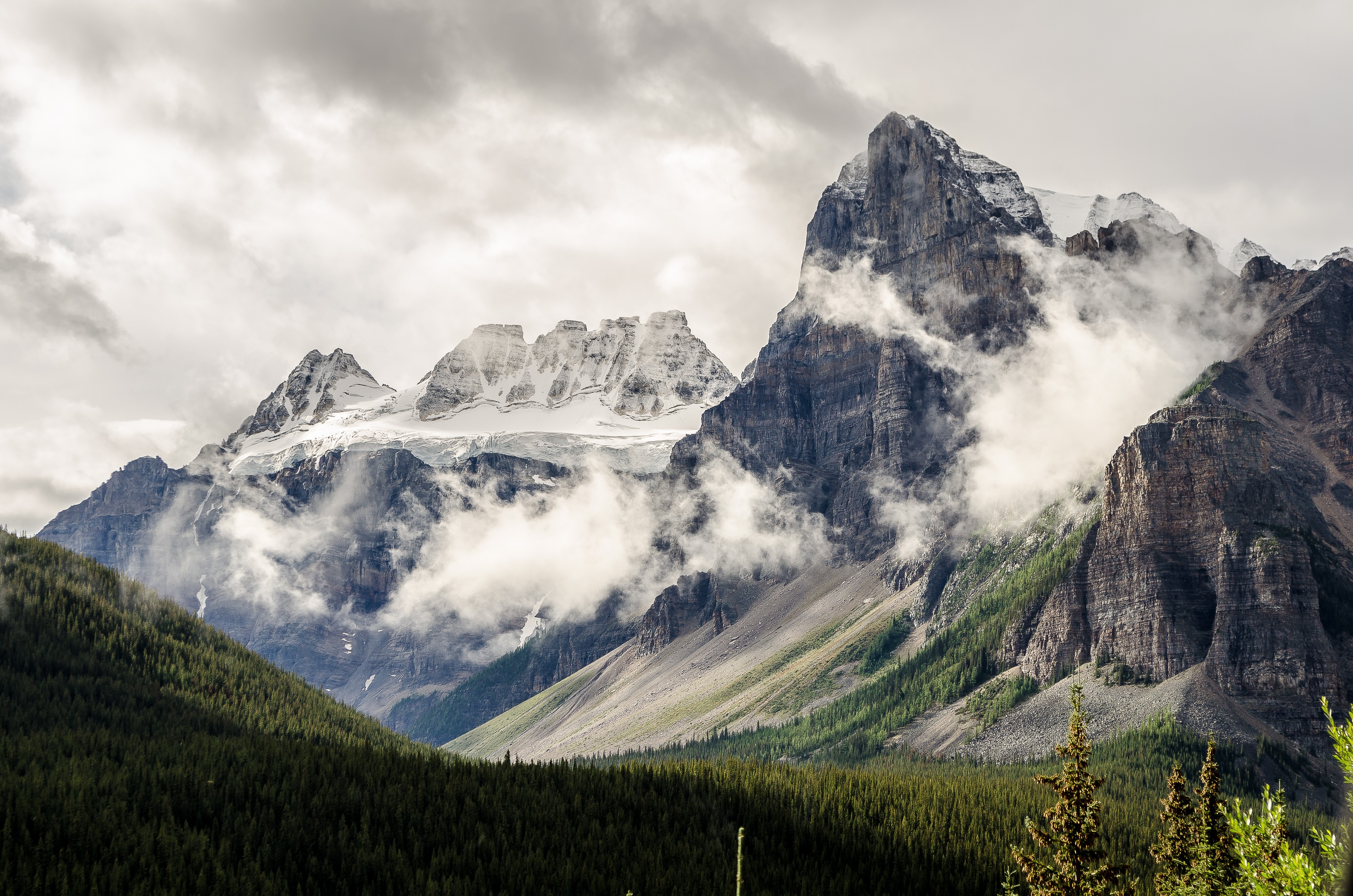 Misty Mountains with Snow-Capped Peaks and Forest HD Wallpaper