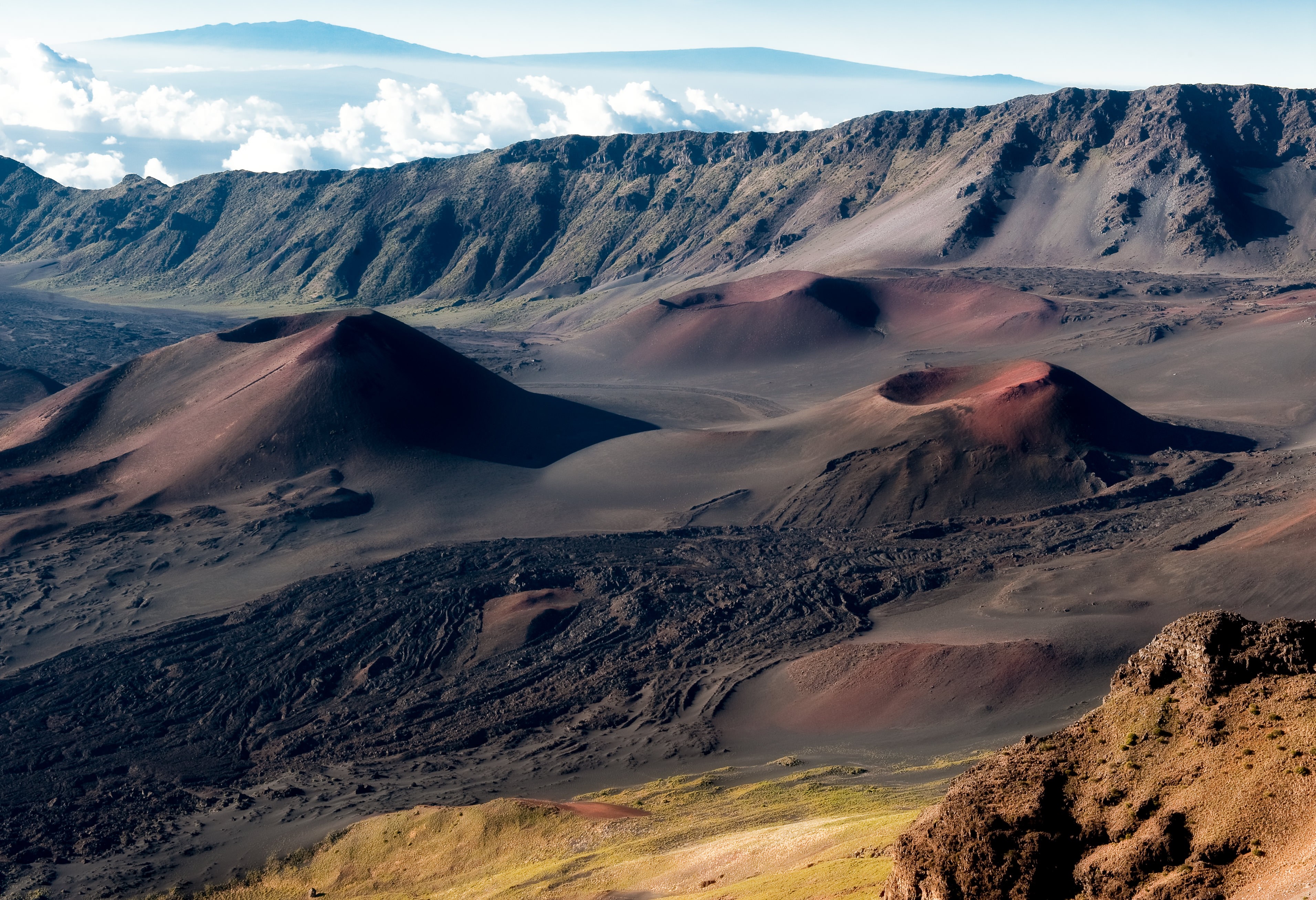 Volcanic craters and mountains under a cloudy sky HD Wallpaper