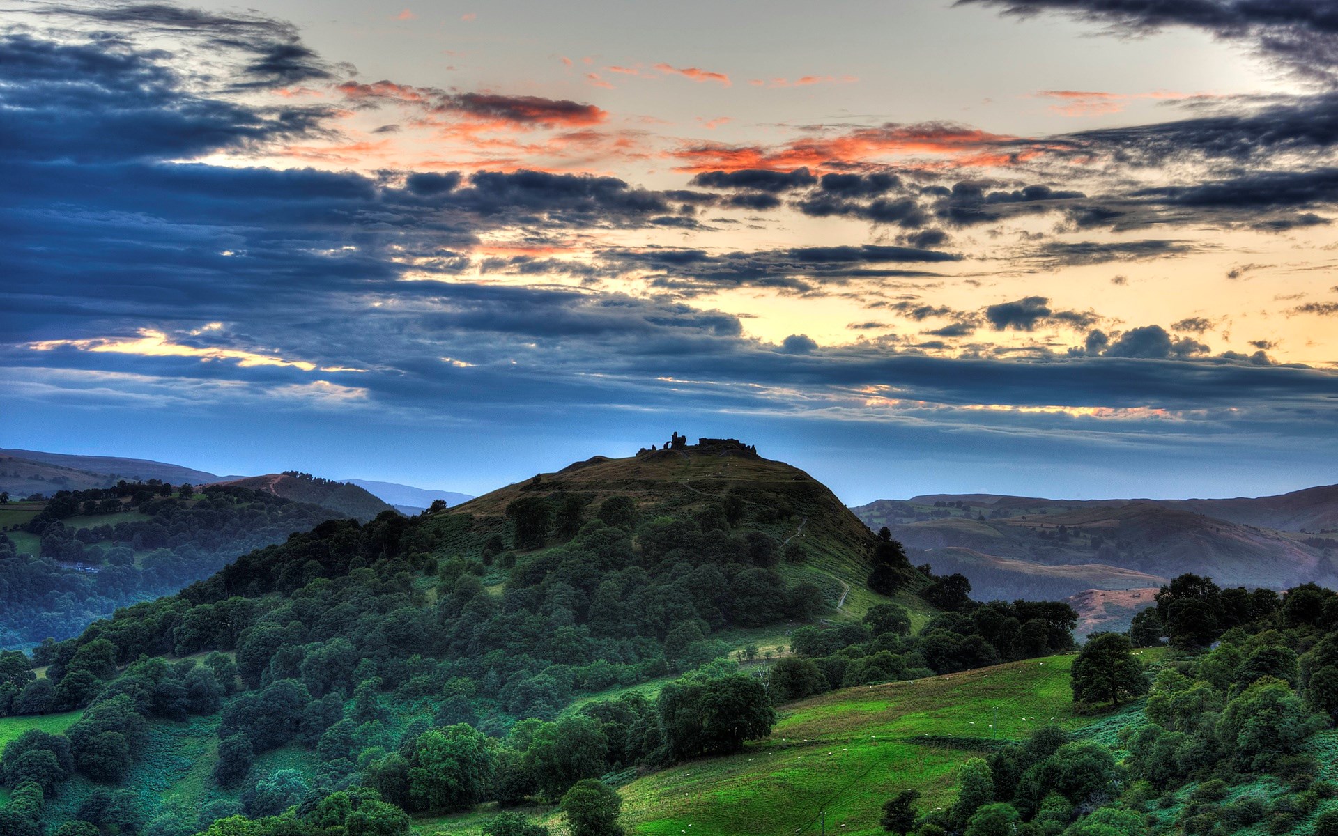 Castle ruins on a grassy hill at sunset HD Wallpaper