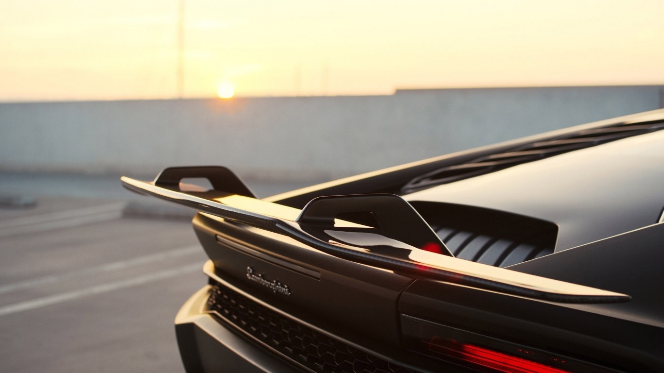 Black Lamborghini Huracan with rear spoiler at sunset HD Wallpaper