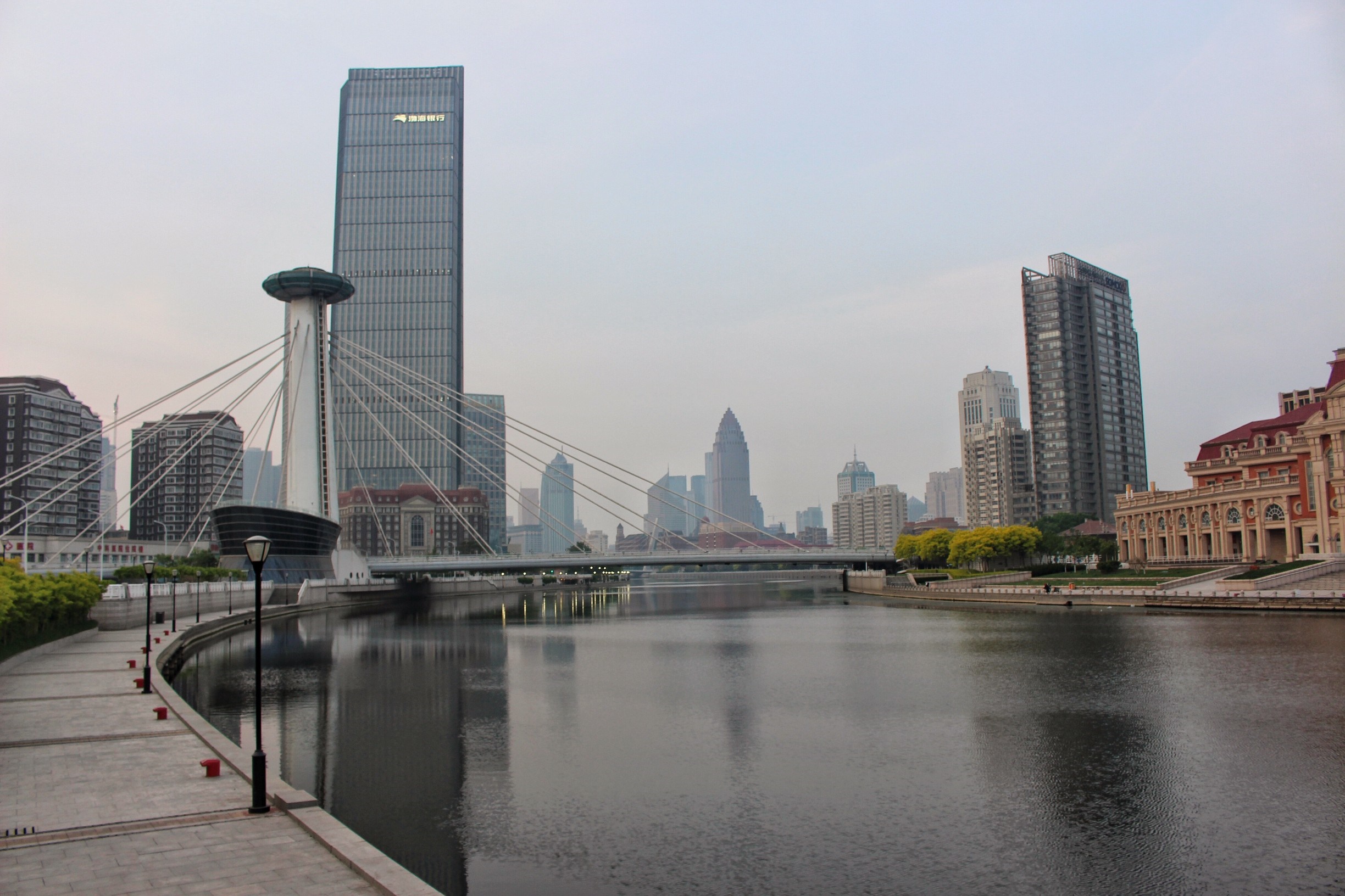 Tianjin cityscape with skyscrapers and a bridge over a river HD Wallpaper