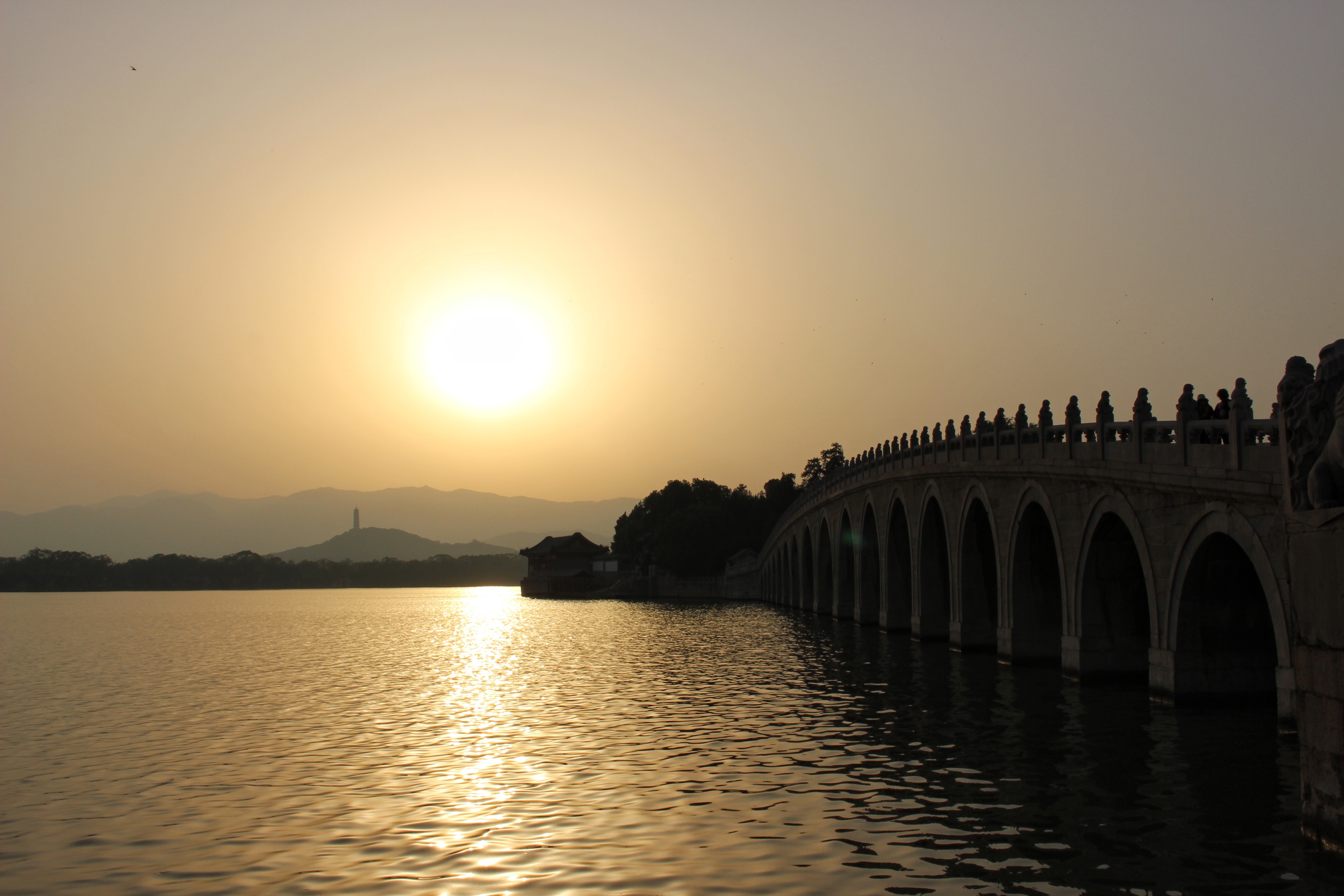 Sunset over a bridge at the Summer Palace in Beijing, China HD Wallpaper