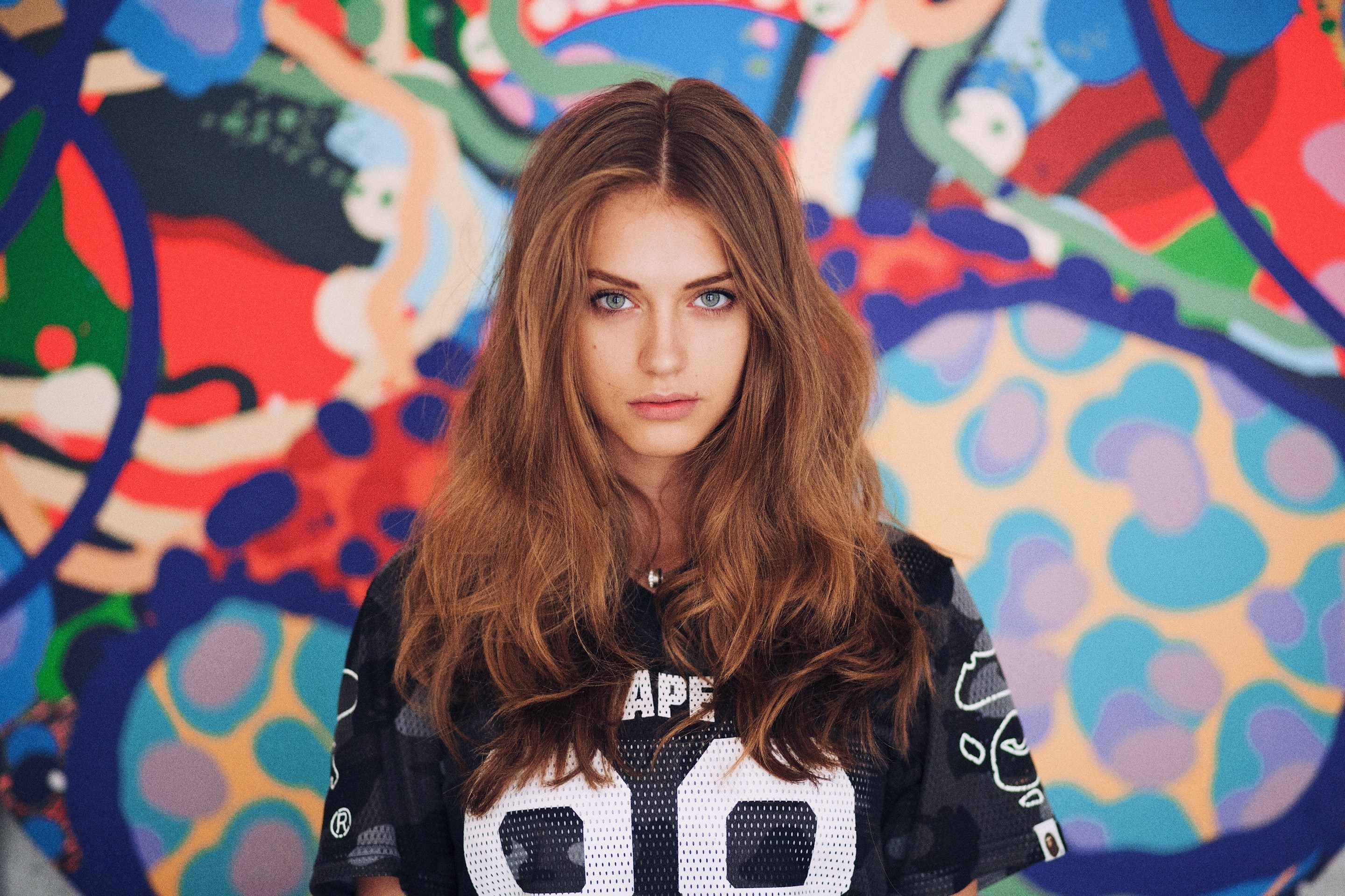 Woman with long brown hair in a colorful graffiti background HD Wallpaper