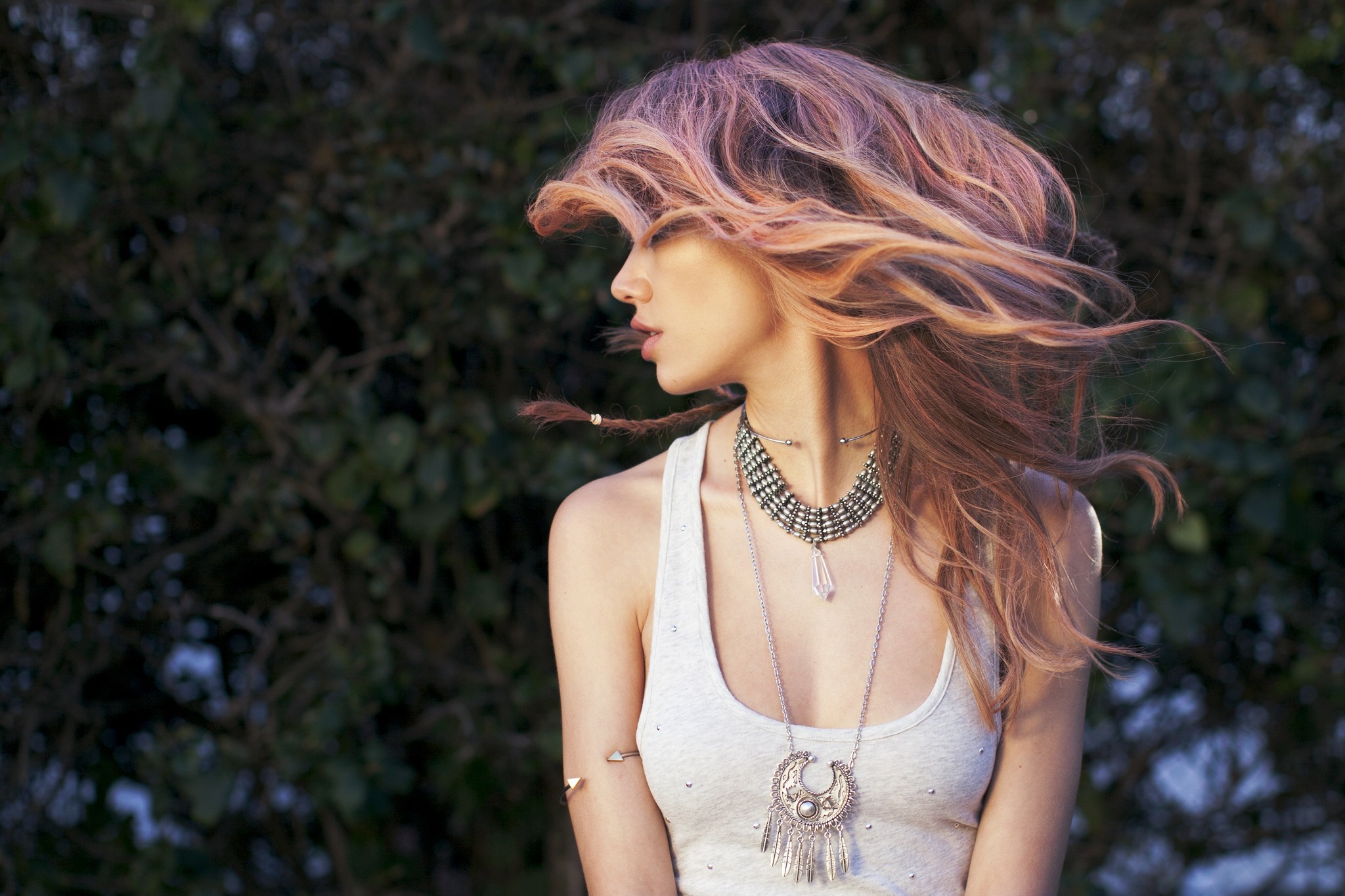 Woman with windblown hair and bohemian jewelry HD Wallpaper