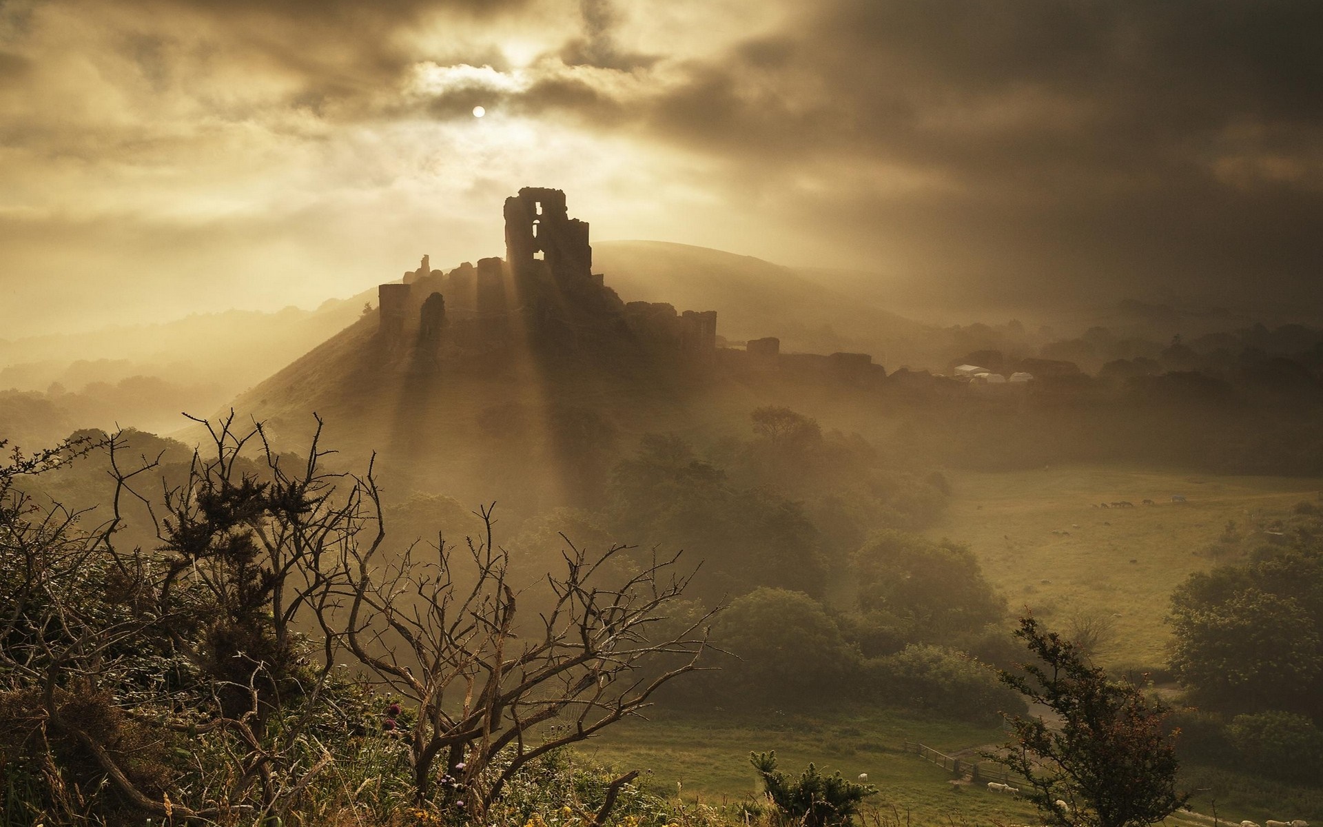 Corfe Castle ruins in mist with sun rays HD Wallpaper