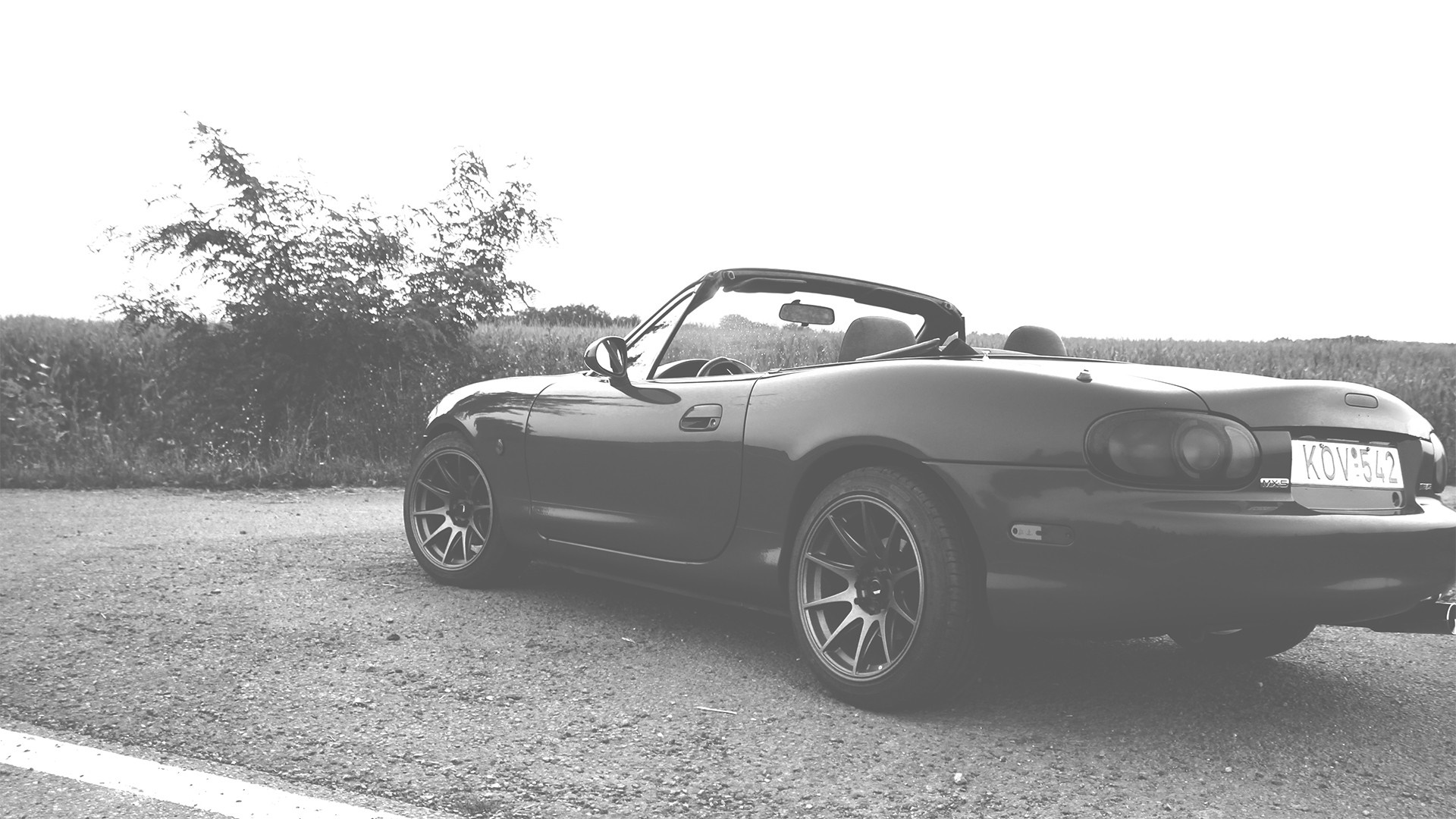 Monochrome Mazda MX-5 convertible parked on a road HD Wallpaper
