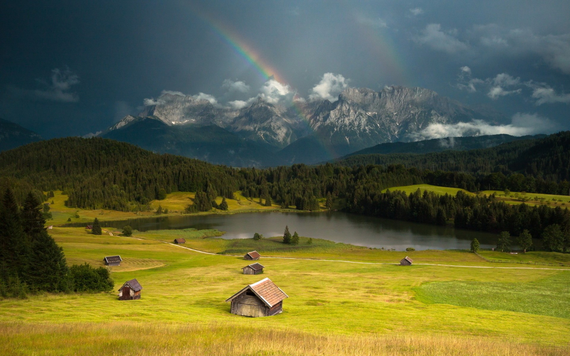 Double rainbow over mountains and lake with cabins HD Wallpaper
