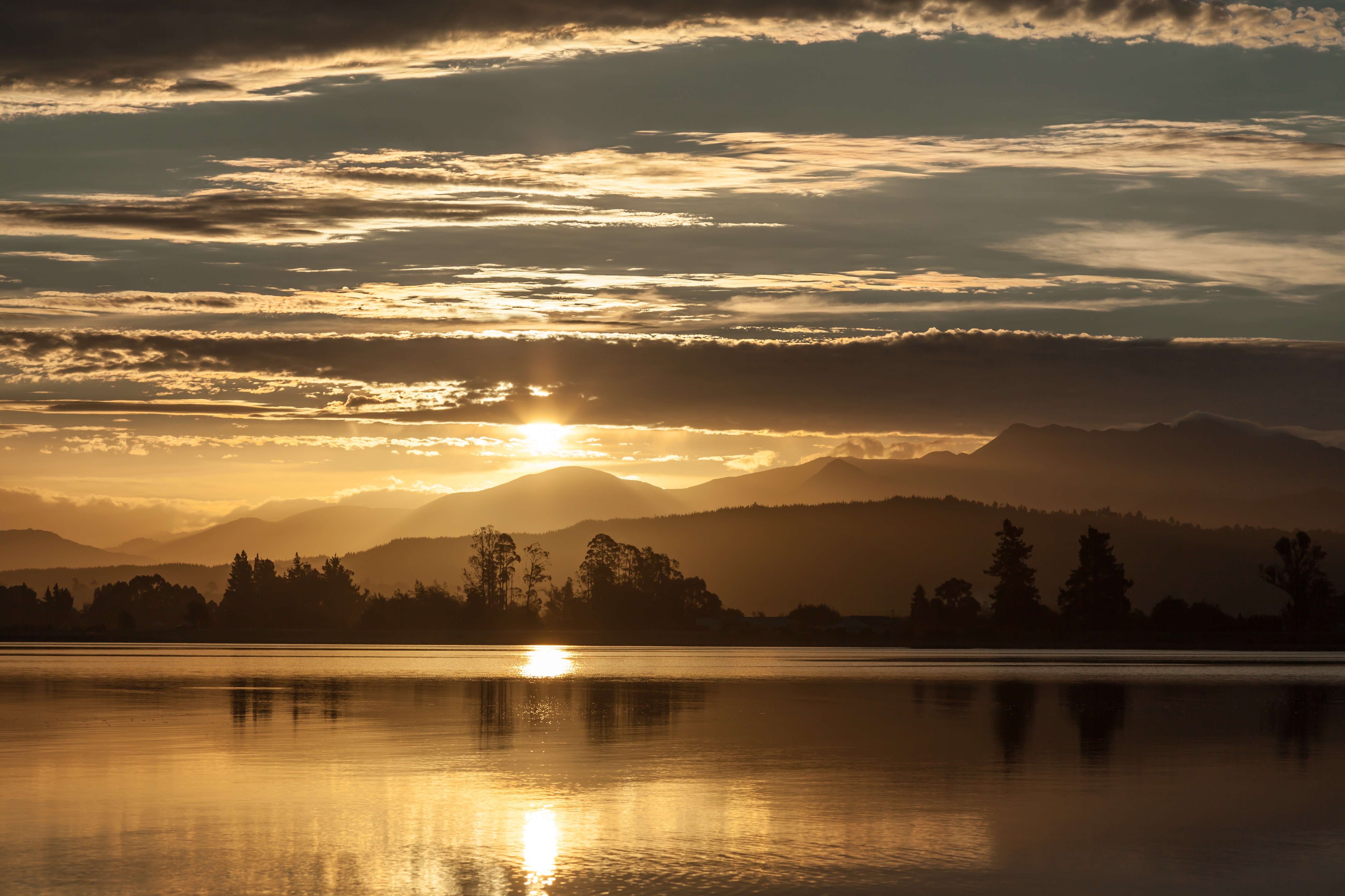 Sunset over mountains and lake with sun rays HD Wallpaper