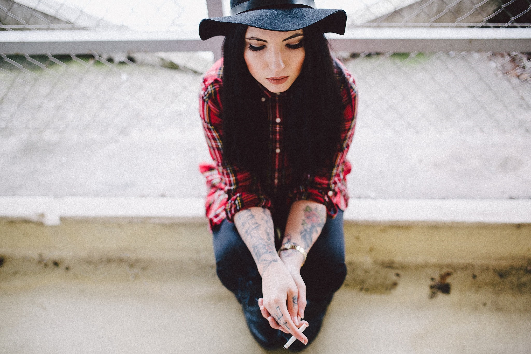 Woman in plaid shirt and hat holding a cigarette HD Wallpaper