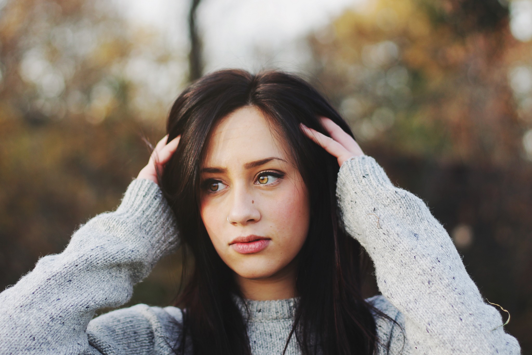 Woman with hands on head wearing a sweater HD Wallpaper