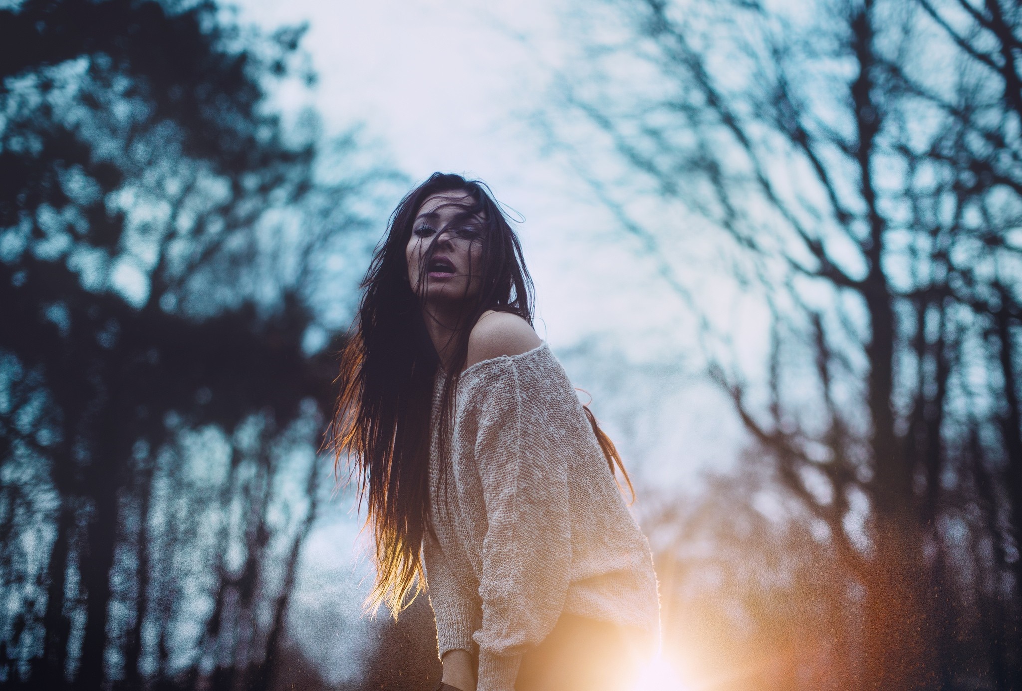 Woman with hair in face in a forest HD Wallpaper