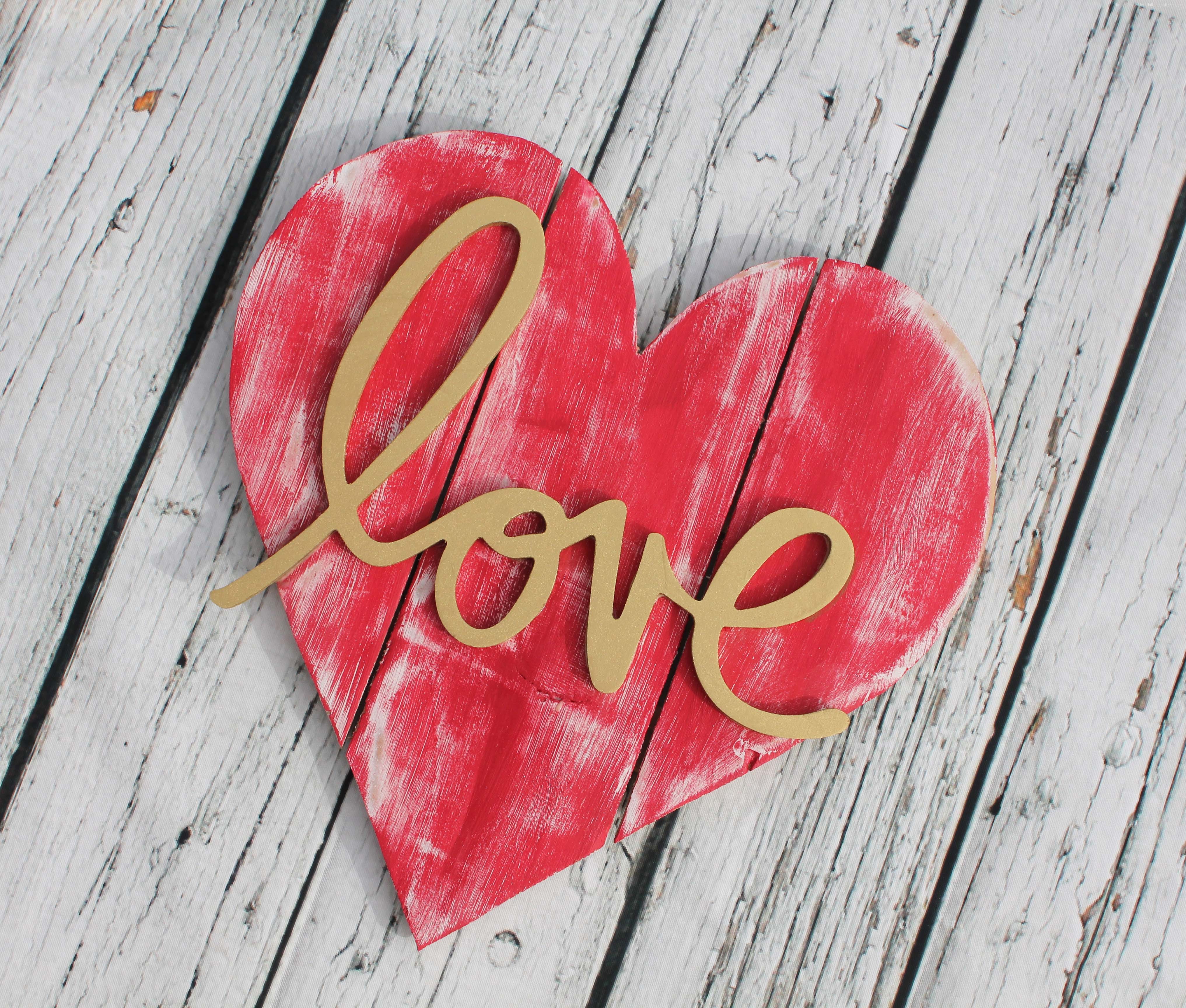 Red heart with the word "love" on a wooden background HD Wallpaper