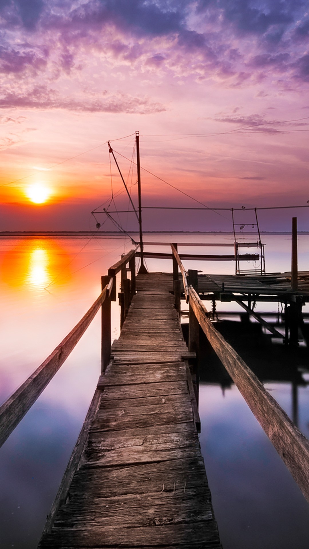 Wooden pier at sunset over the water HD Wallpaper