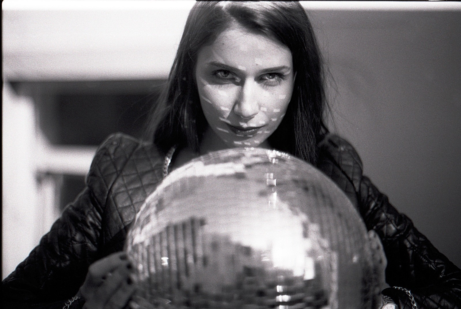 Woman with disco ball in black and white portrait HD Wallpaper