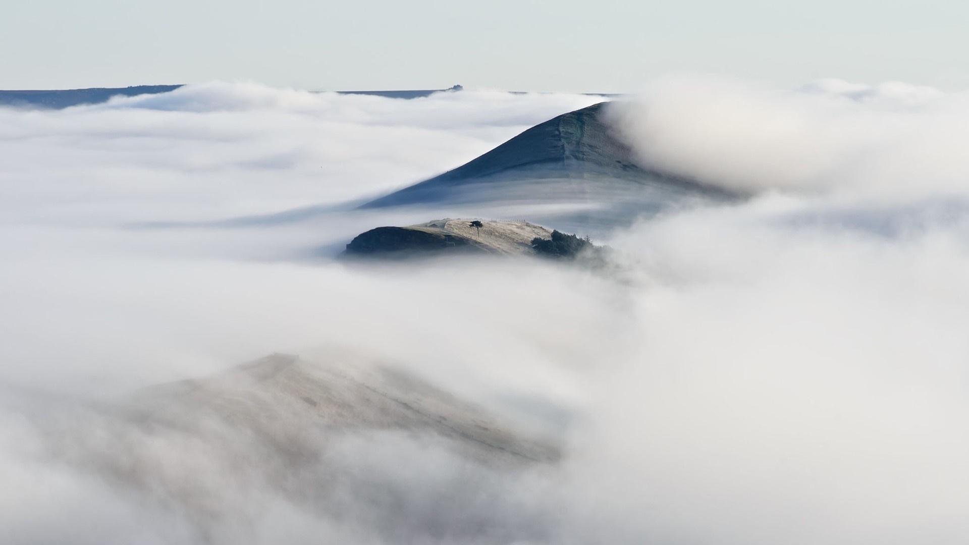 Mountains covered in fog and mist HD Wallpaper