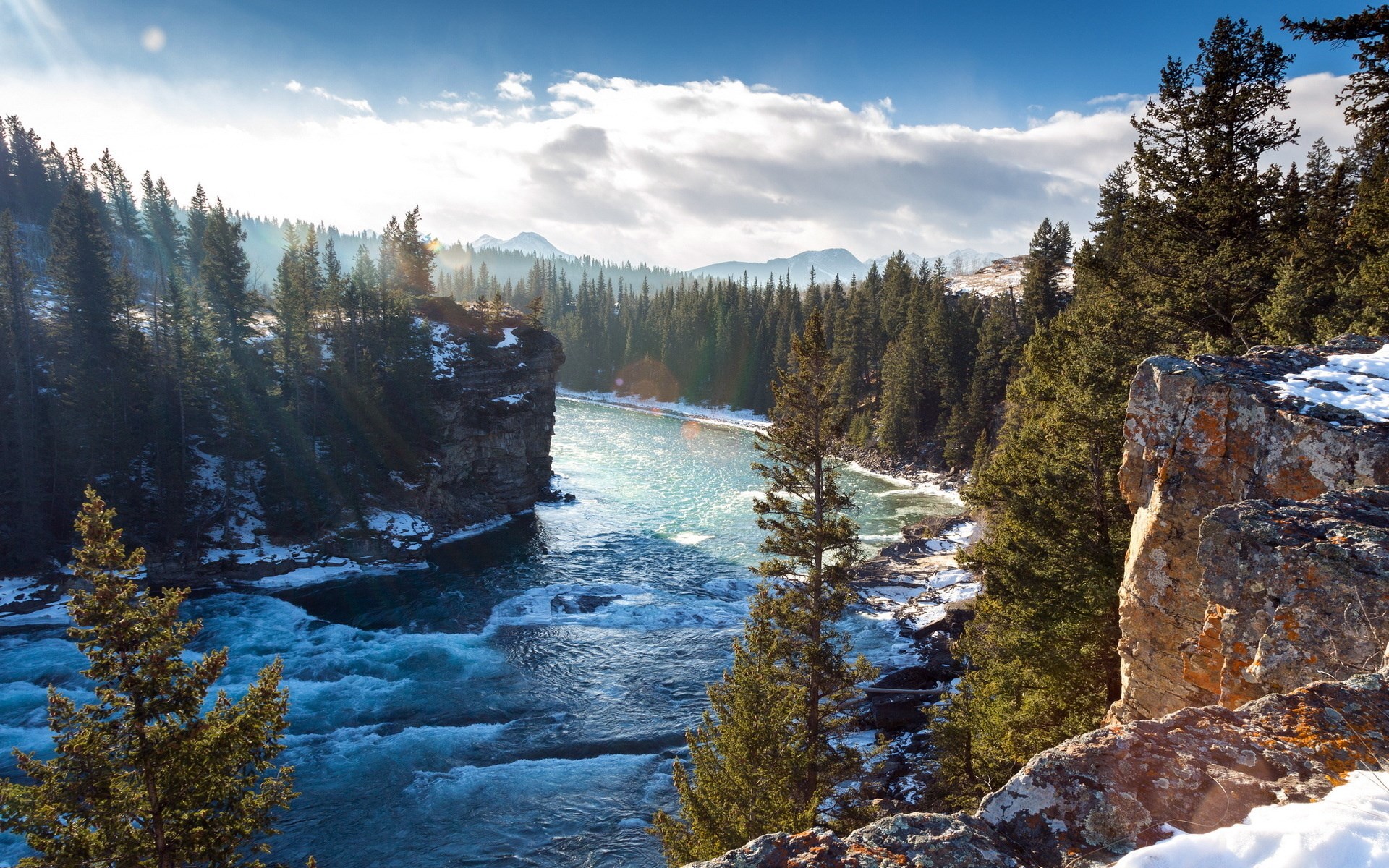 River flowing through a forest with snow HD Wallpaper