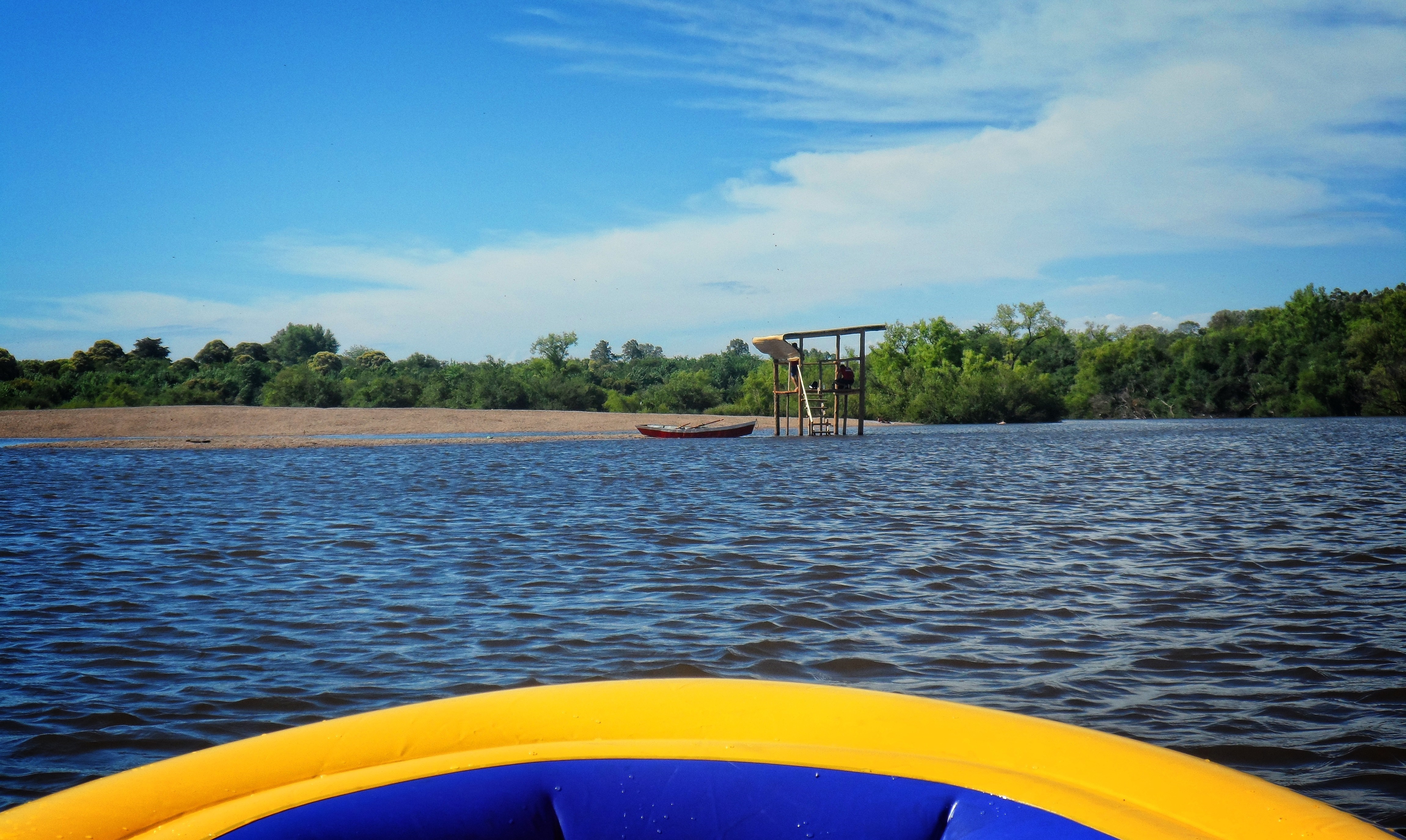 Kayaking on a river with a wooden structure HD Wallpaper