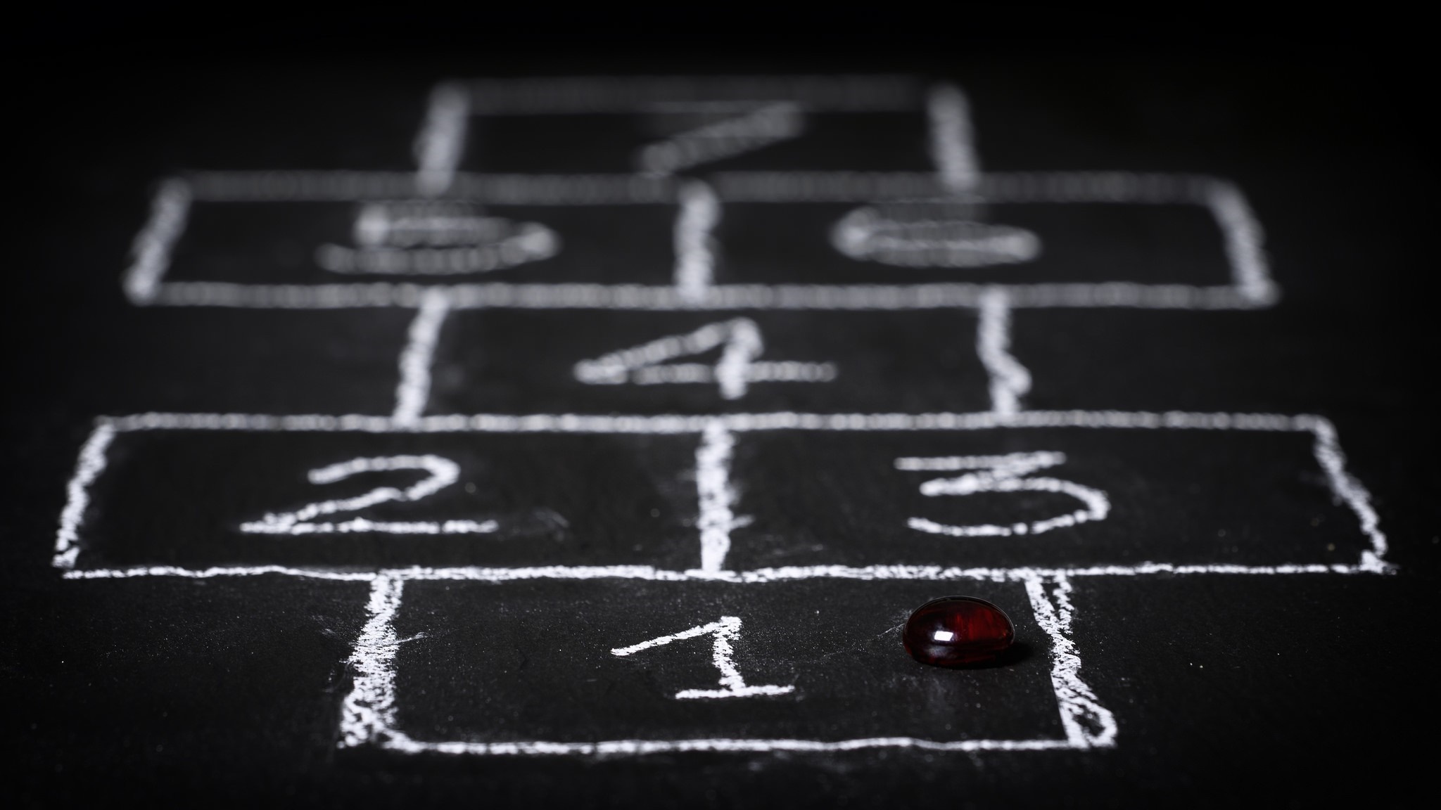 Hopscotch drawn on a blackboard with a marker HD Wallpaper