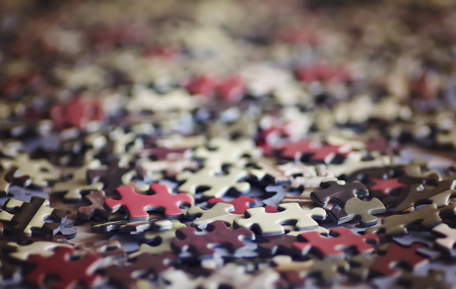 Close up of scattered puzzle pieces HD Wallpaper