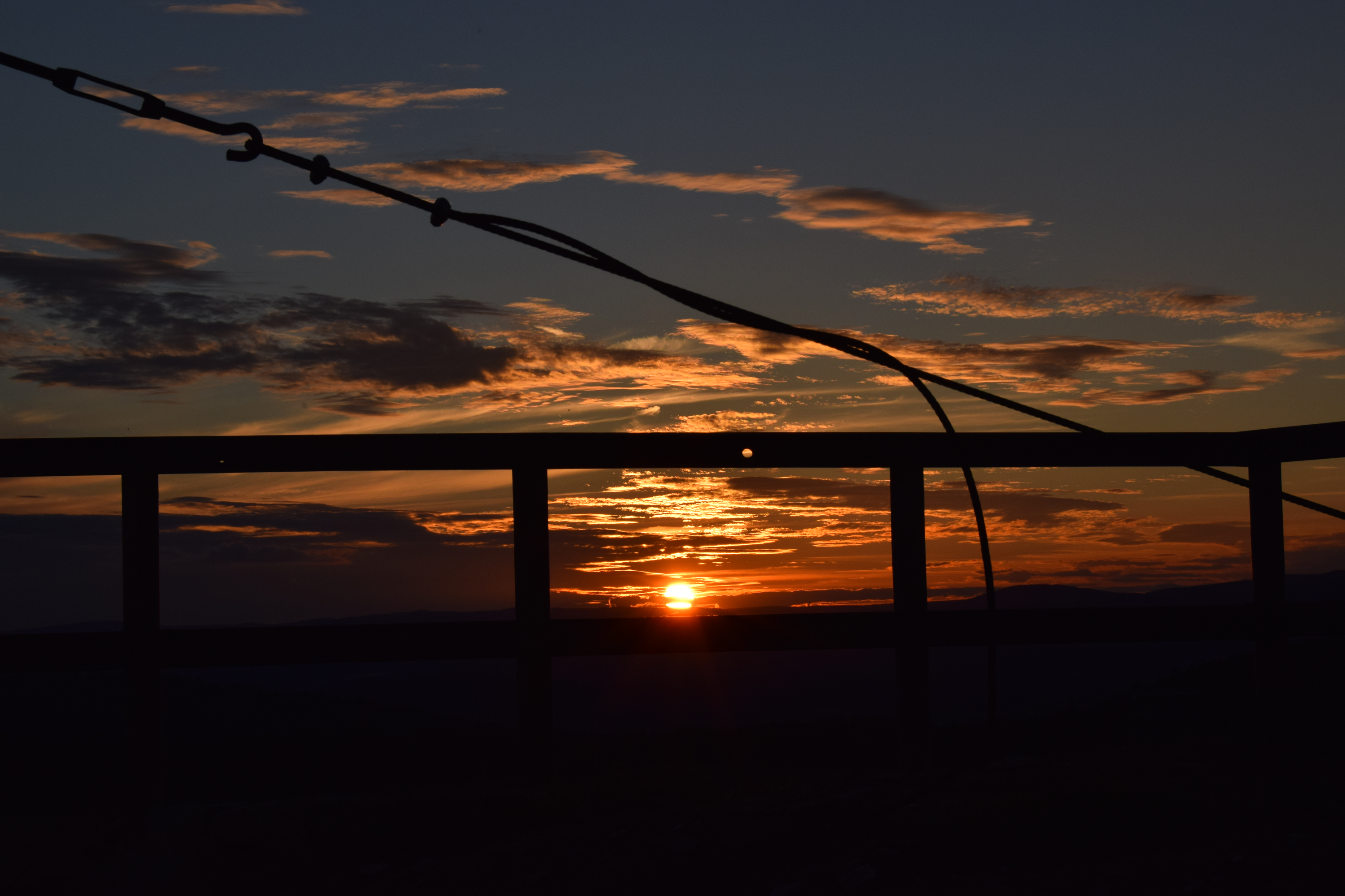 Sunset over the horizon with clouds and cables HD Wallpaper