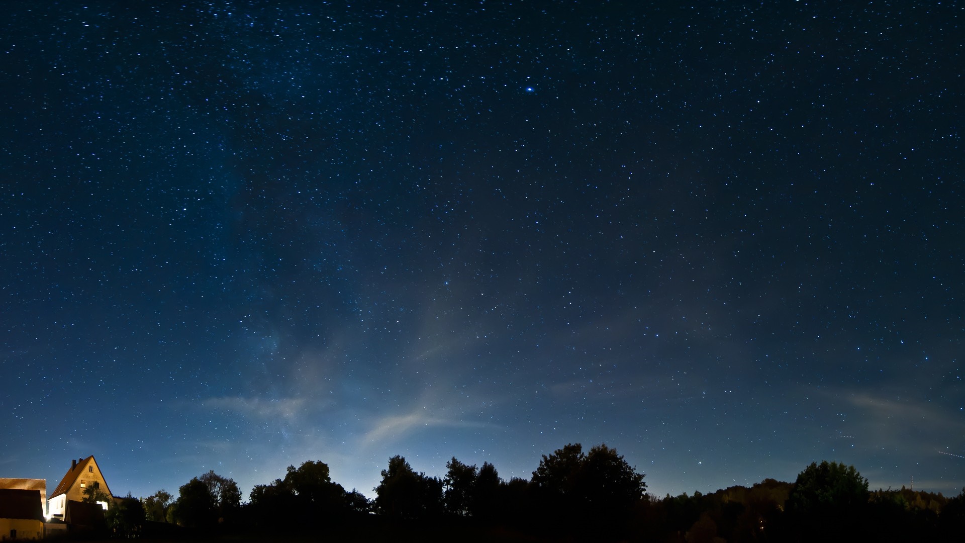 Night sky full of stars over trees and houses HD Wallpaper