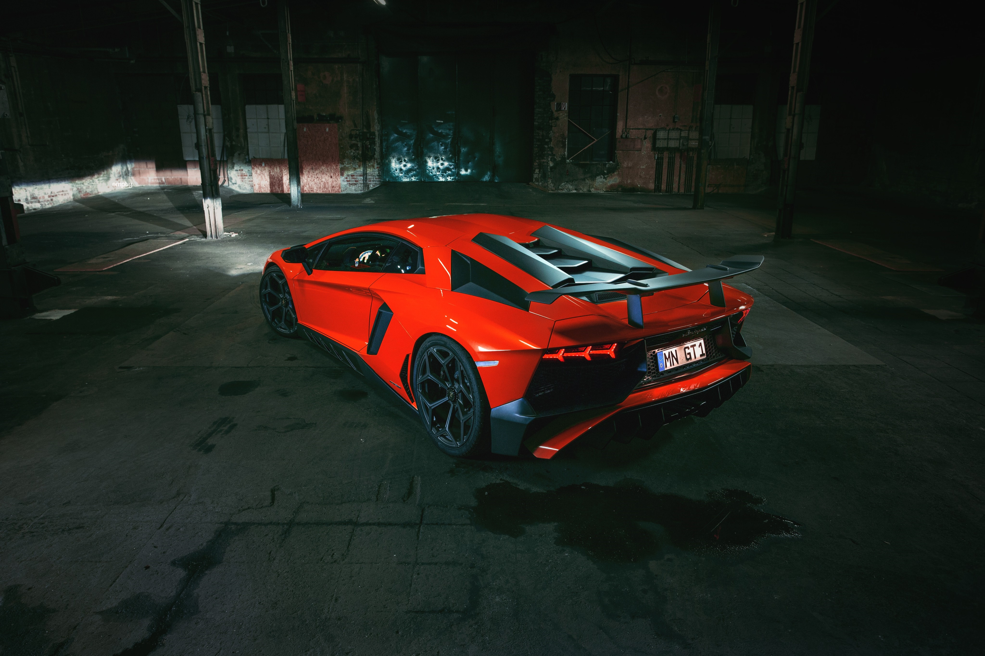 Red Lamborghini Aventador parked in a dark industrial building HD Wallpaper