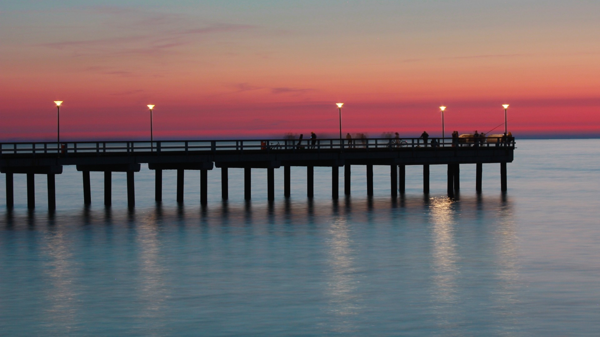 Pier at sunset over the ocean HD Wallpaper