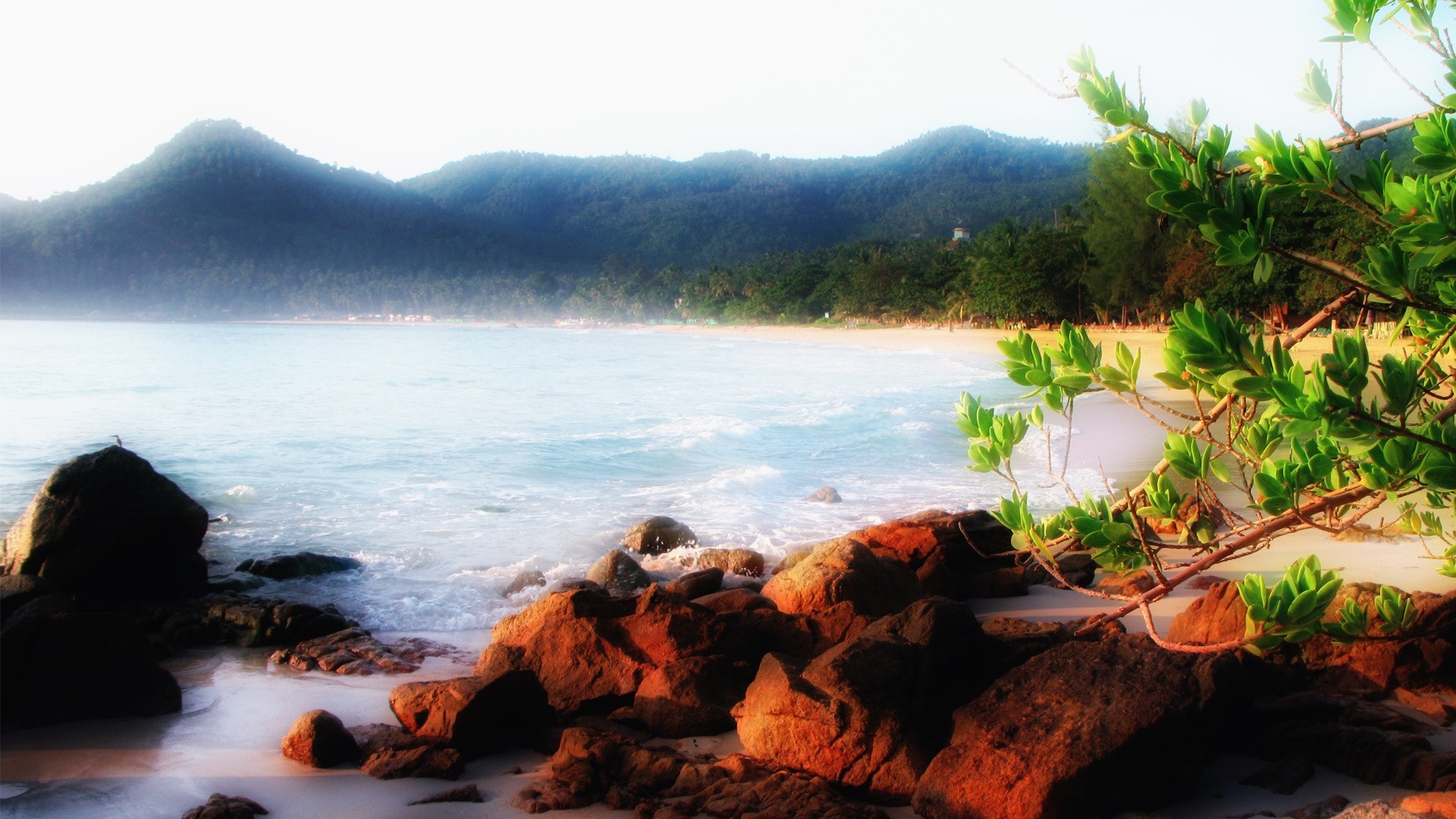Rocky beach with mountains and ocean at sunrise HD Wallpaper