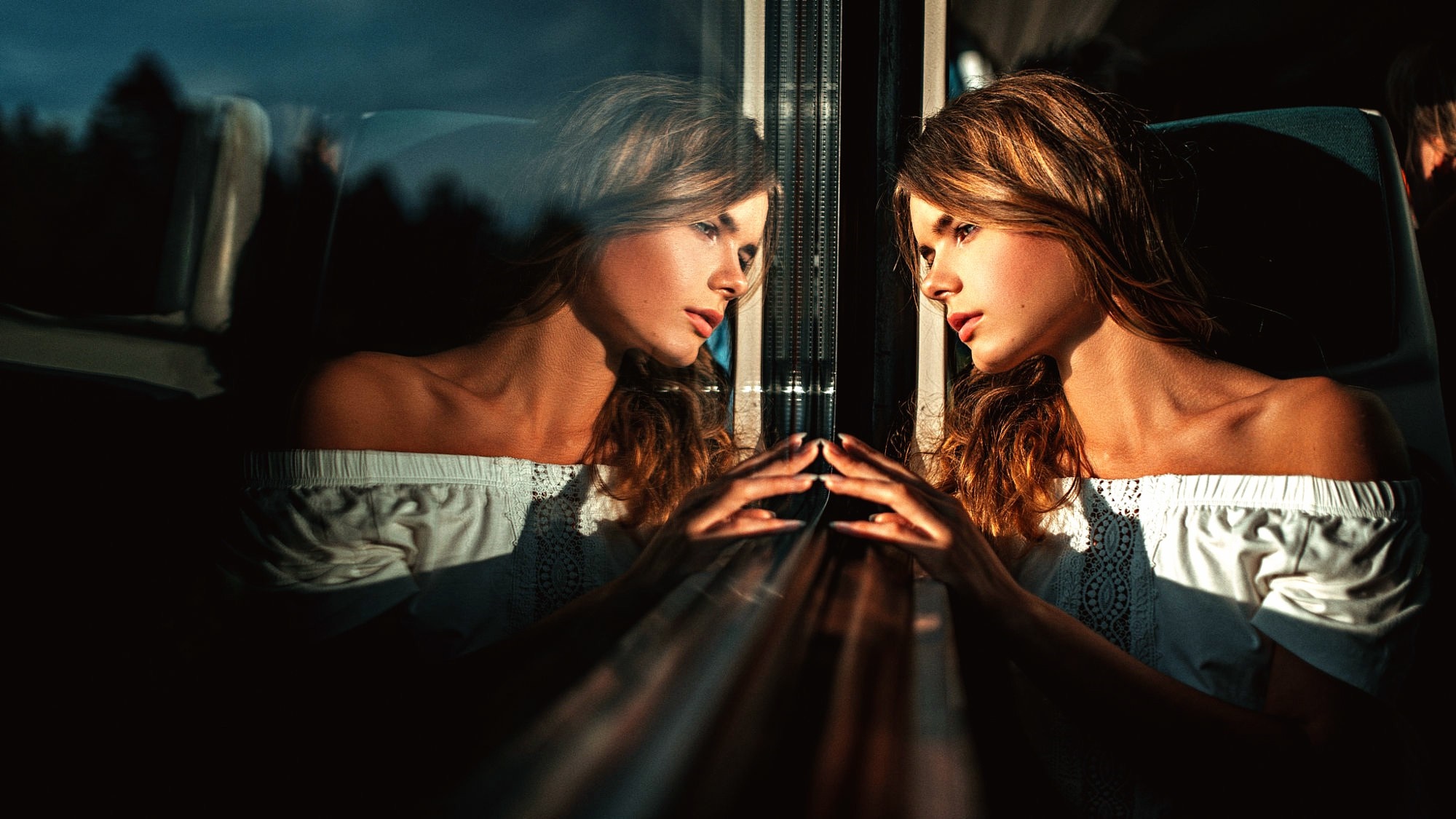 Woman looking at her reflection in a window HD Wallpaper