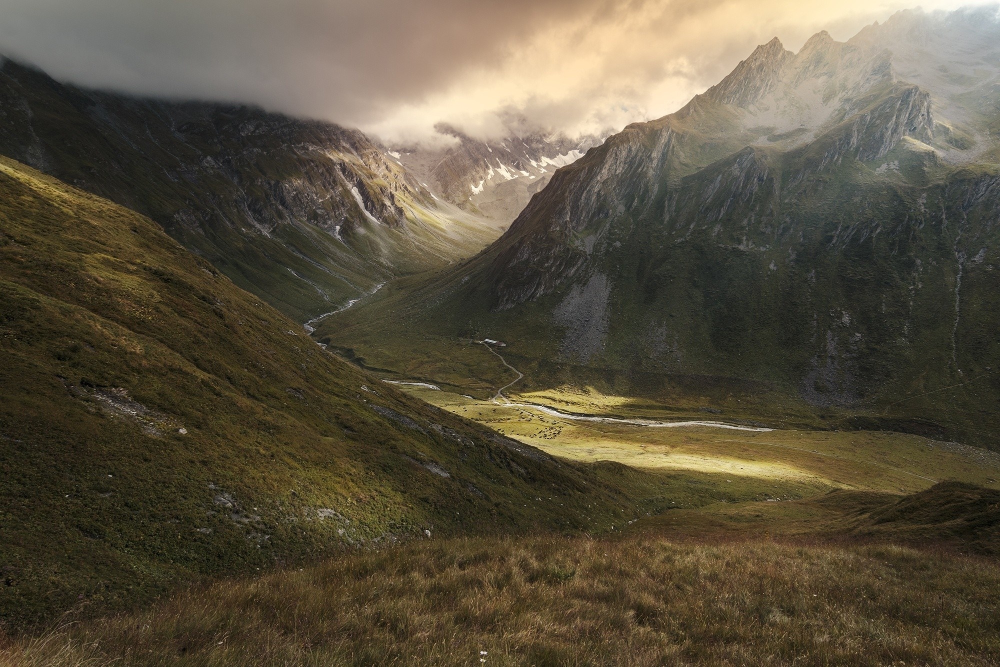 Valley with a river and mountains under clouds HD Wallpaper