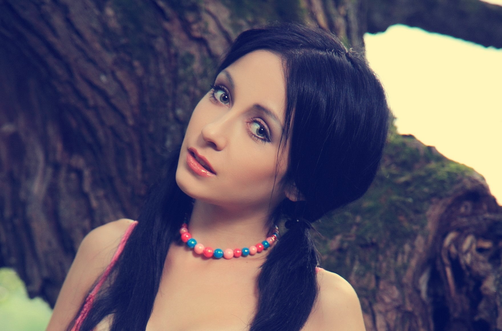 Woman with black hair and beaded necklace HD Wallpaper