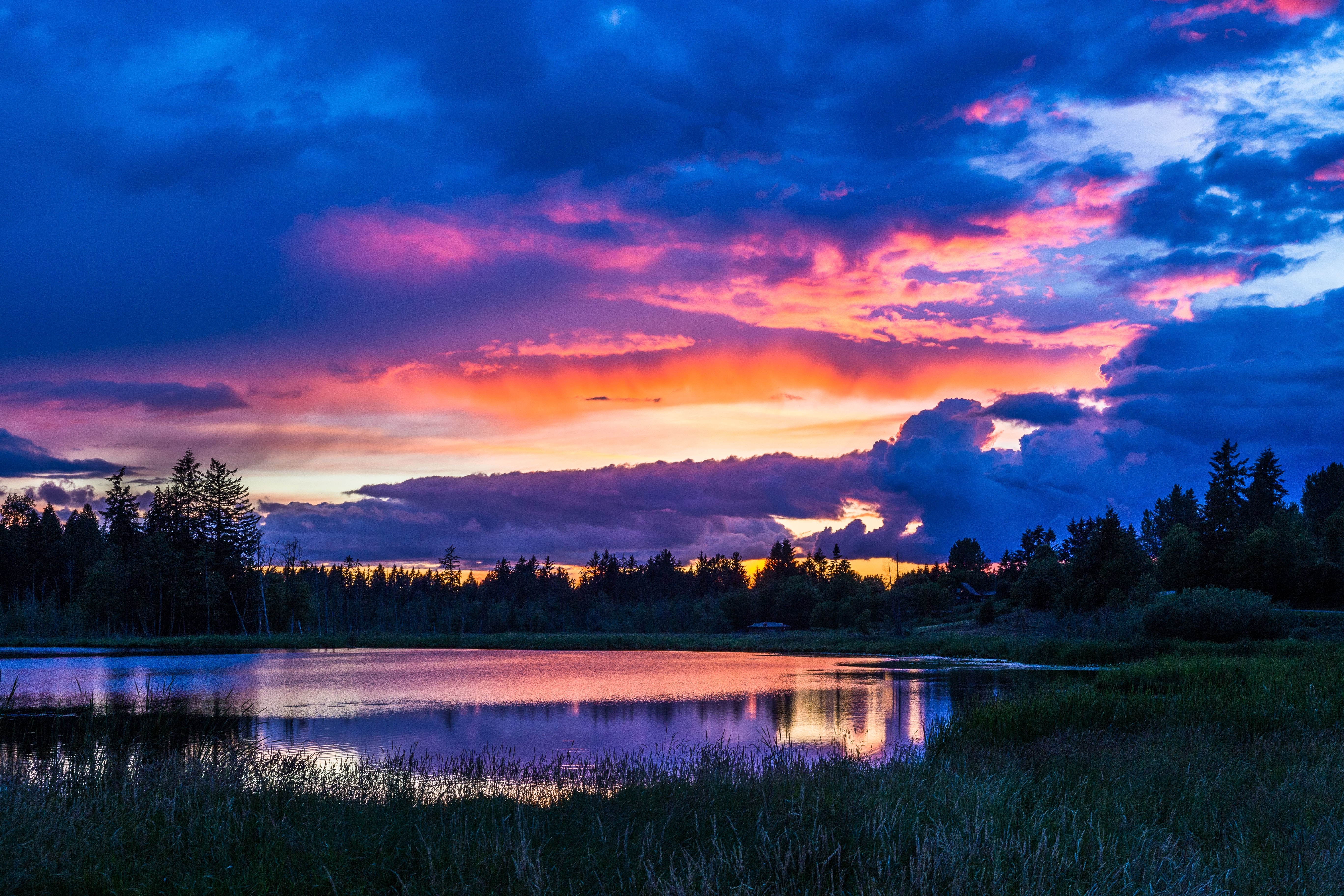 Sunset over a lake with colorful clouds and trees HD Wallpaper