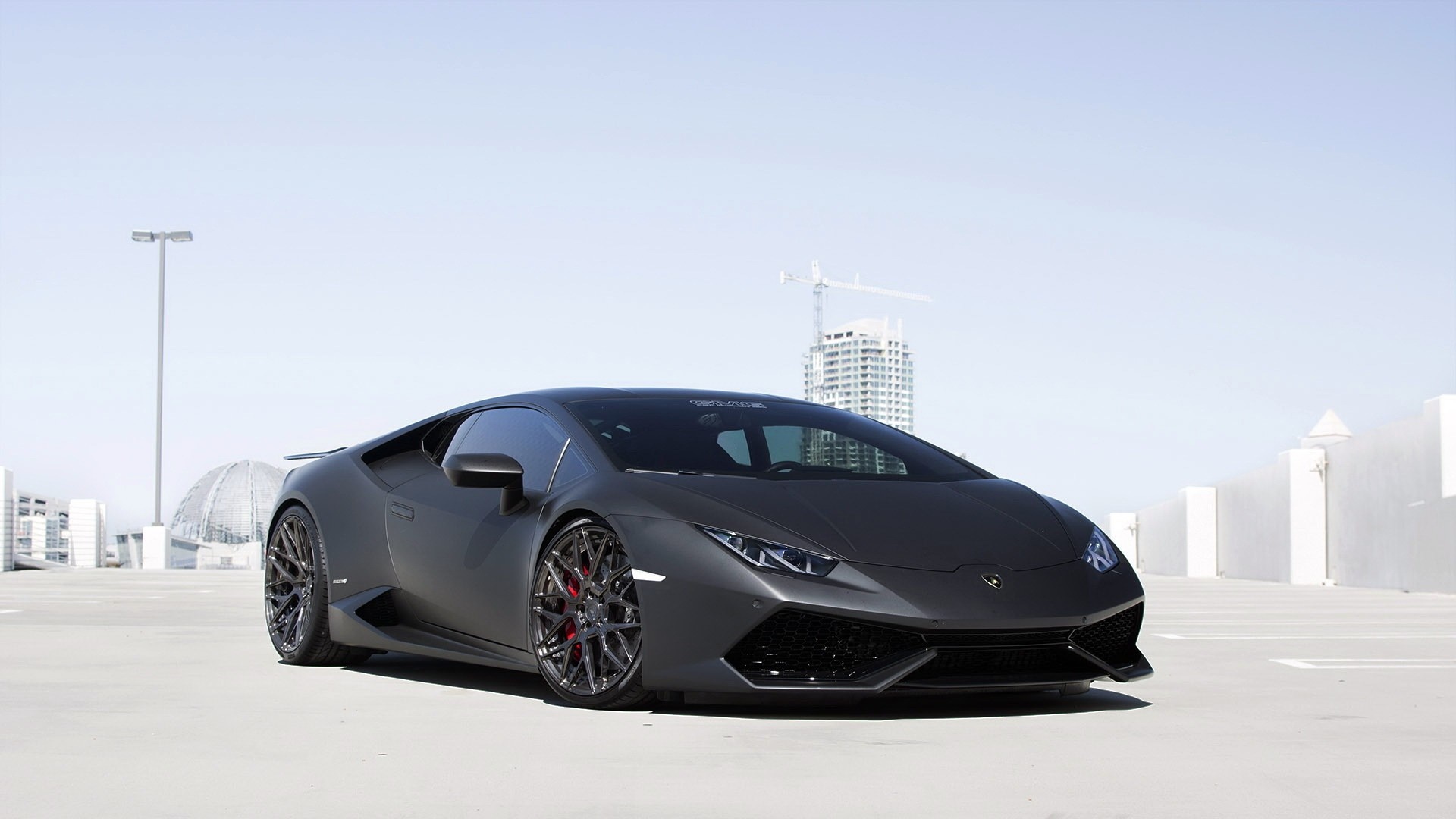 Matte black Lamborghini Huracan in urban setting HD Wallpaper