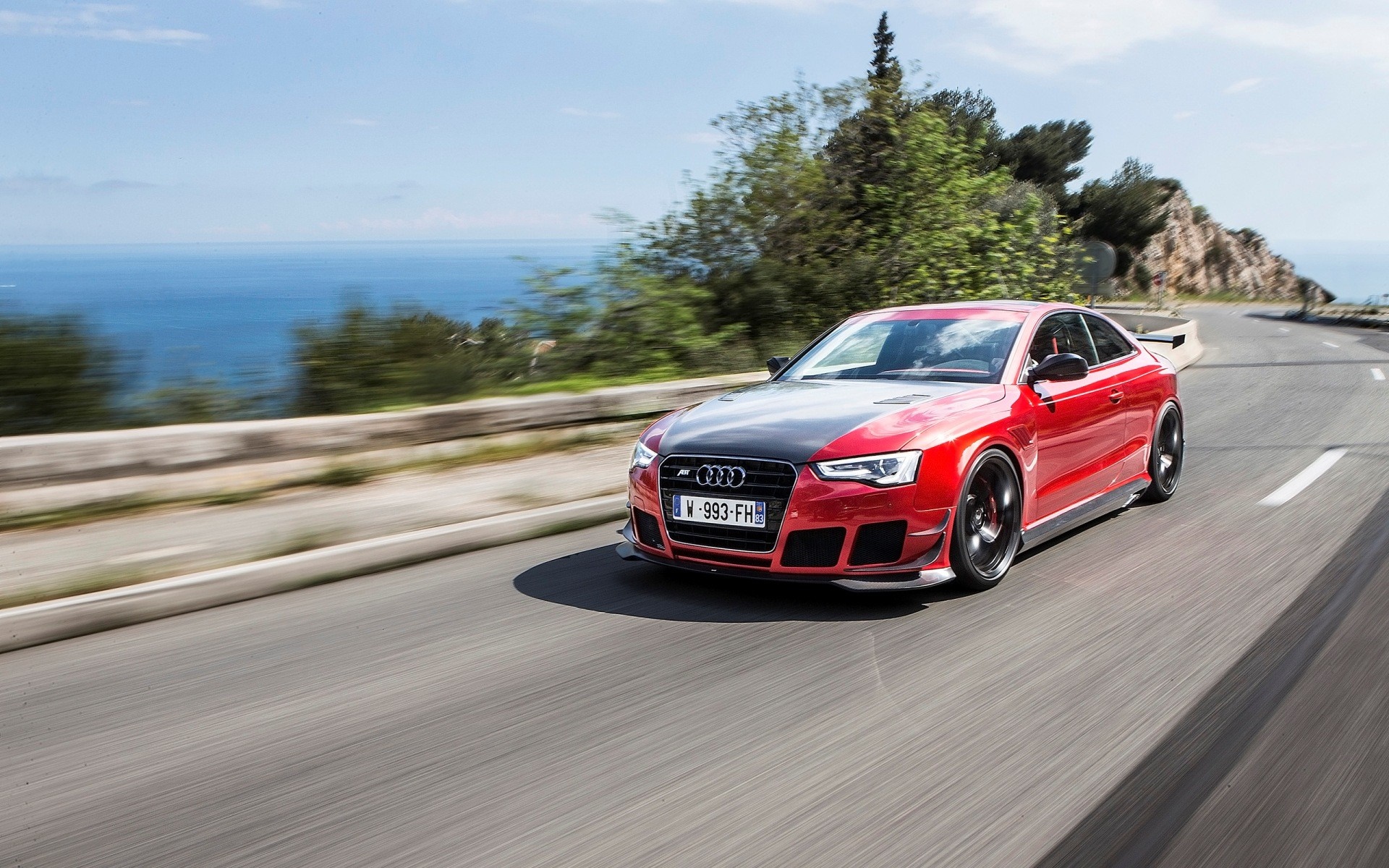Red Audi RS5 Coupe with custom body kit on a coastal road HD Wallpaper