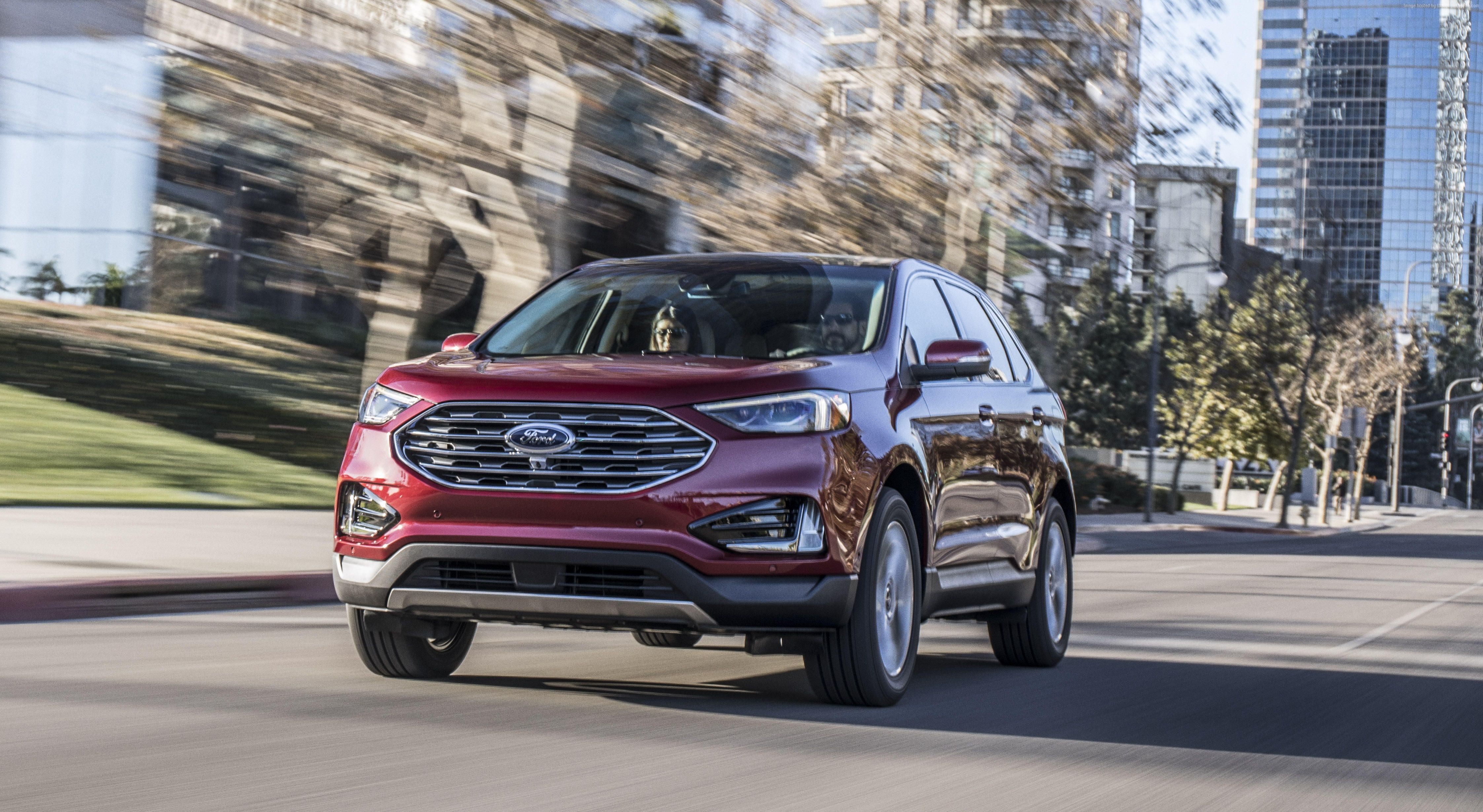 Red Ford Edge driving on a city street HD Wallpaper