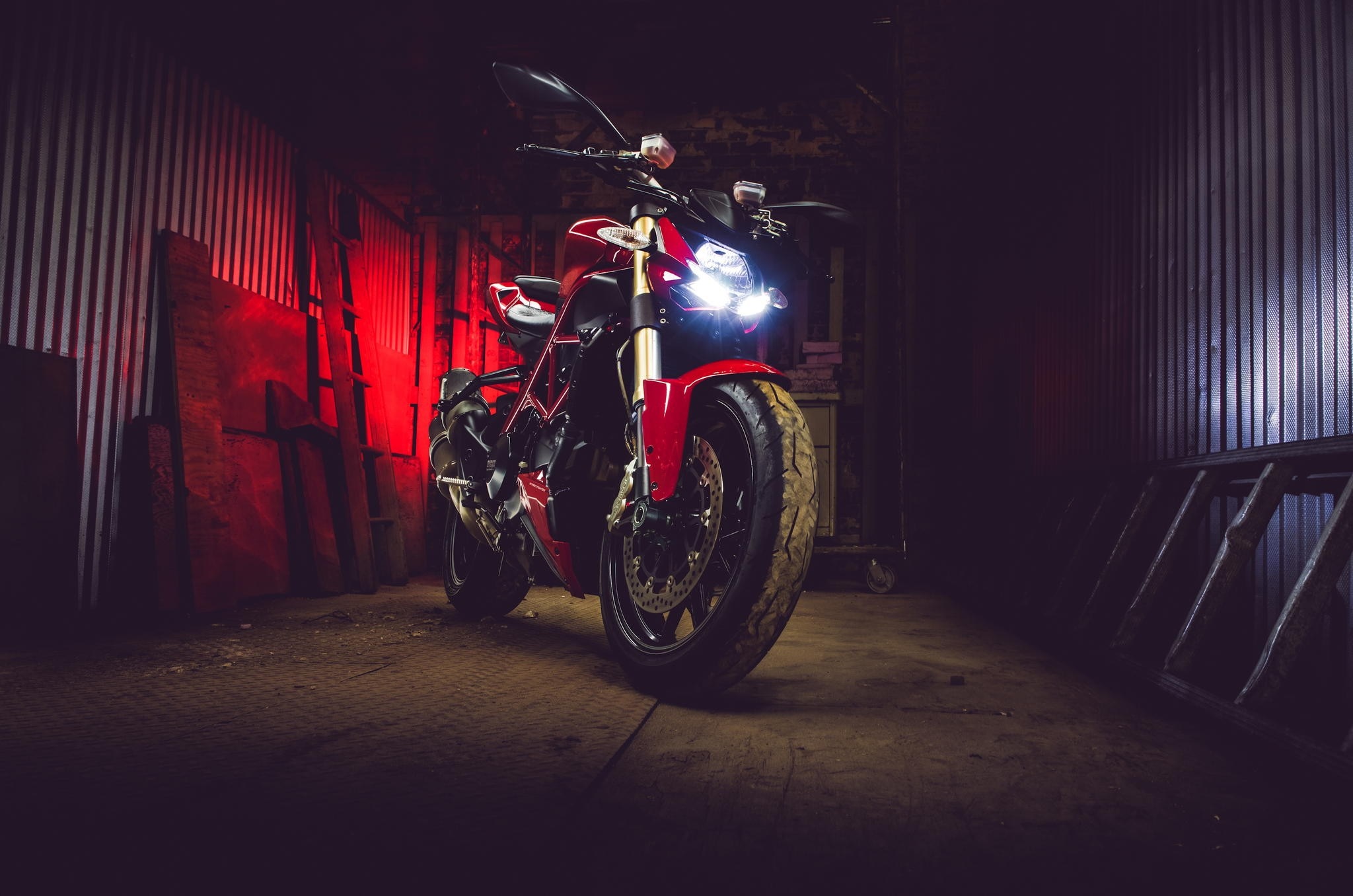 Red Ducati Streetfighter 848 motorcycle in a dark garage HD Wallpaper