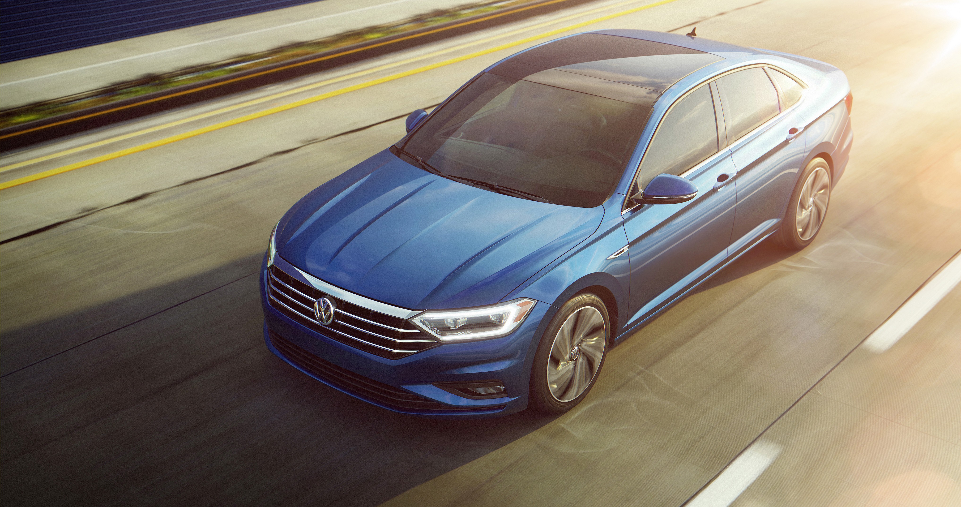 Blue 2018 Volkswagen Jetta driving on a highway HD Wallpaper