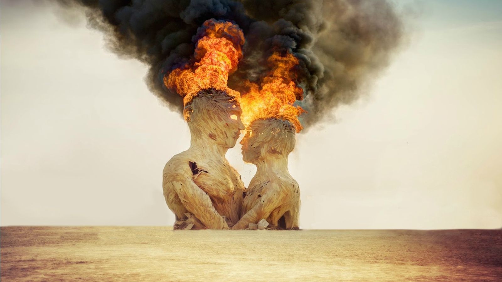 Two wooden figures burning at the top of their heads HD Wallpaper