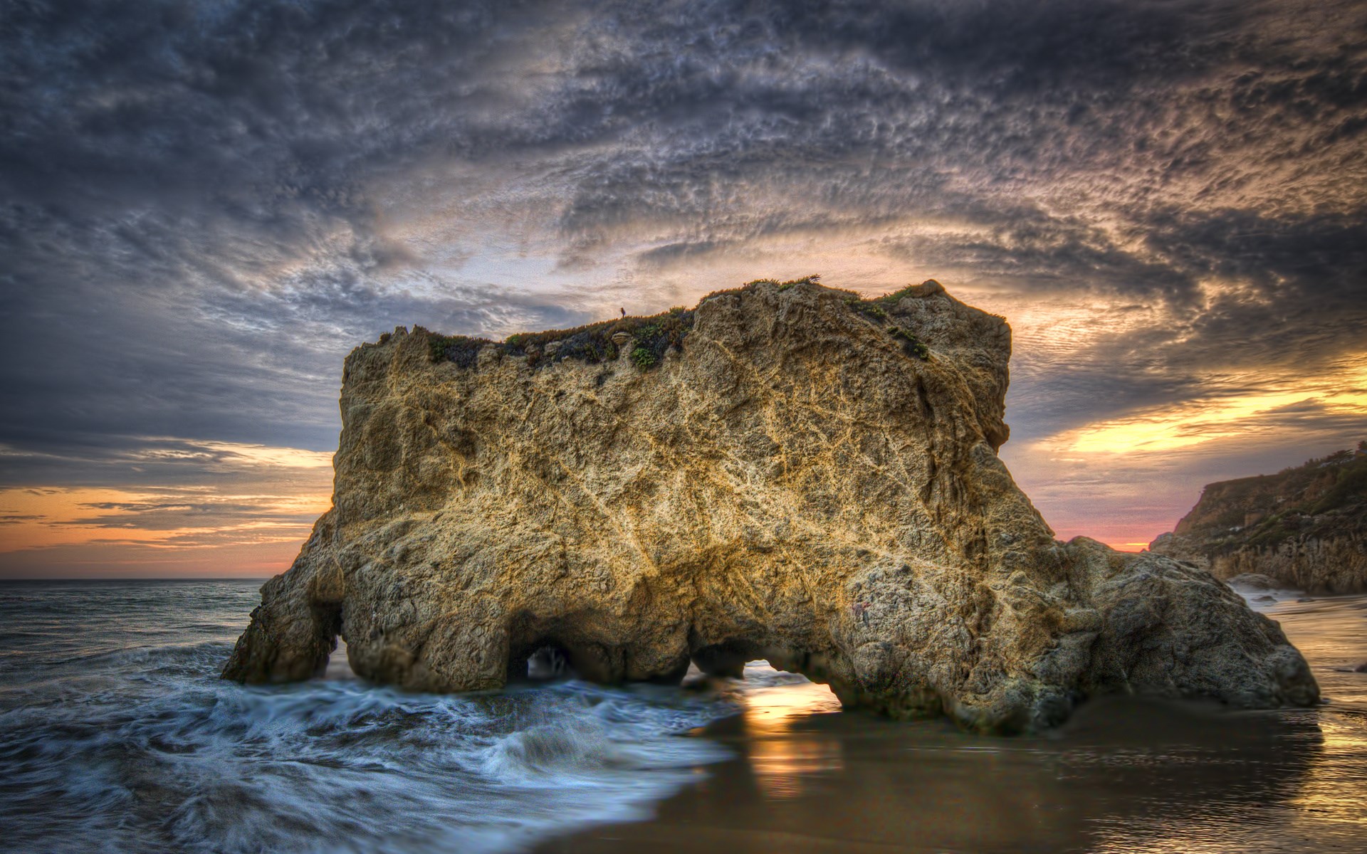 Rock formation with arches at El Matador State Beach at sunset HD Wallpaper