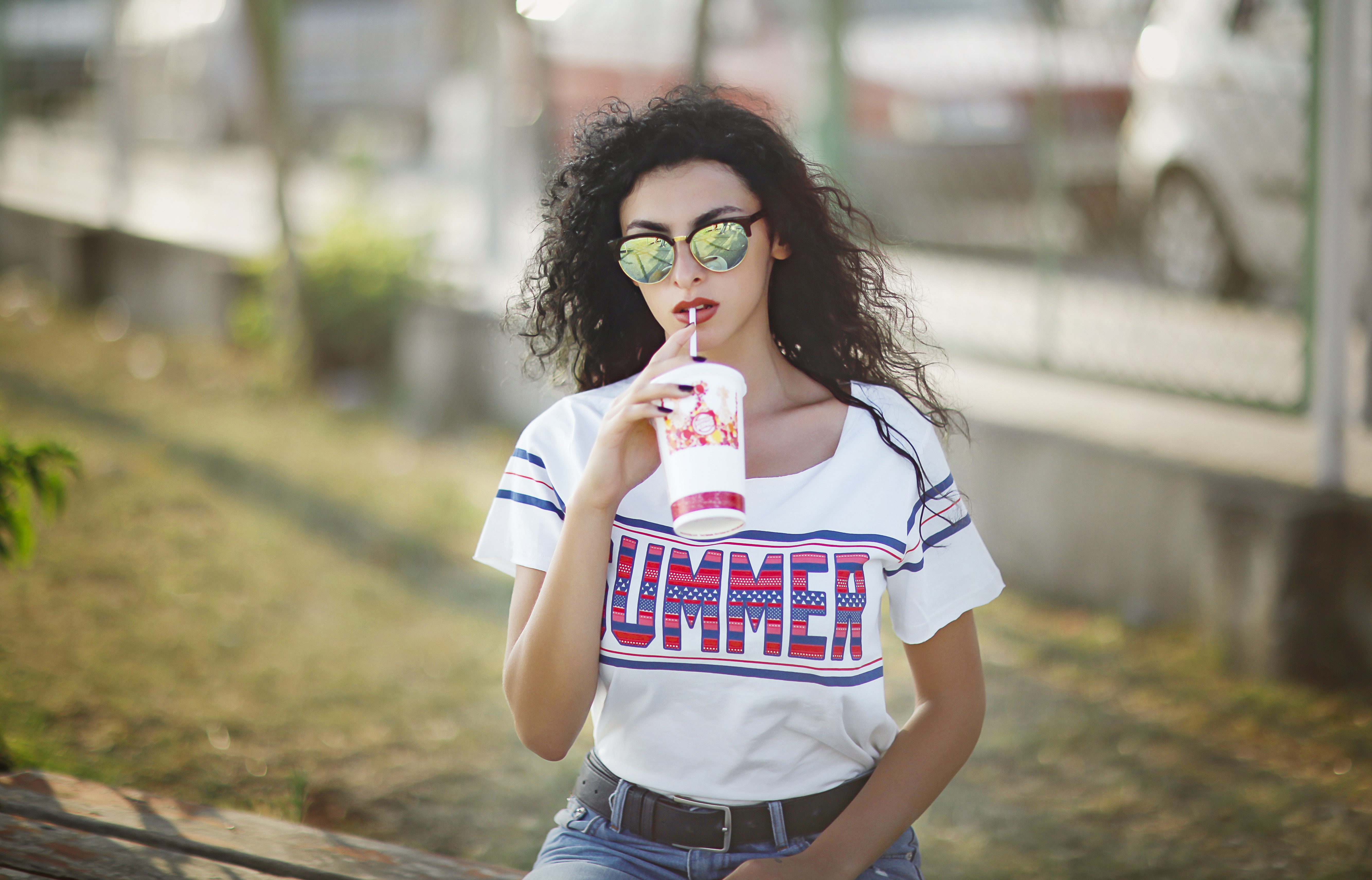 Woman in sunglasses drinking from a cup HD Wallpaper