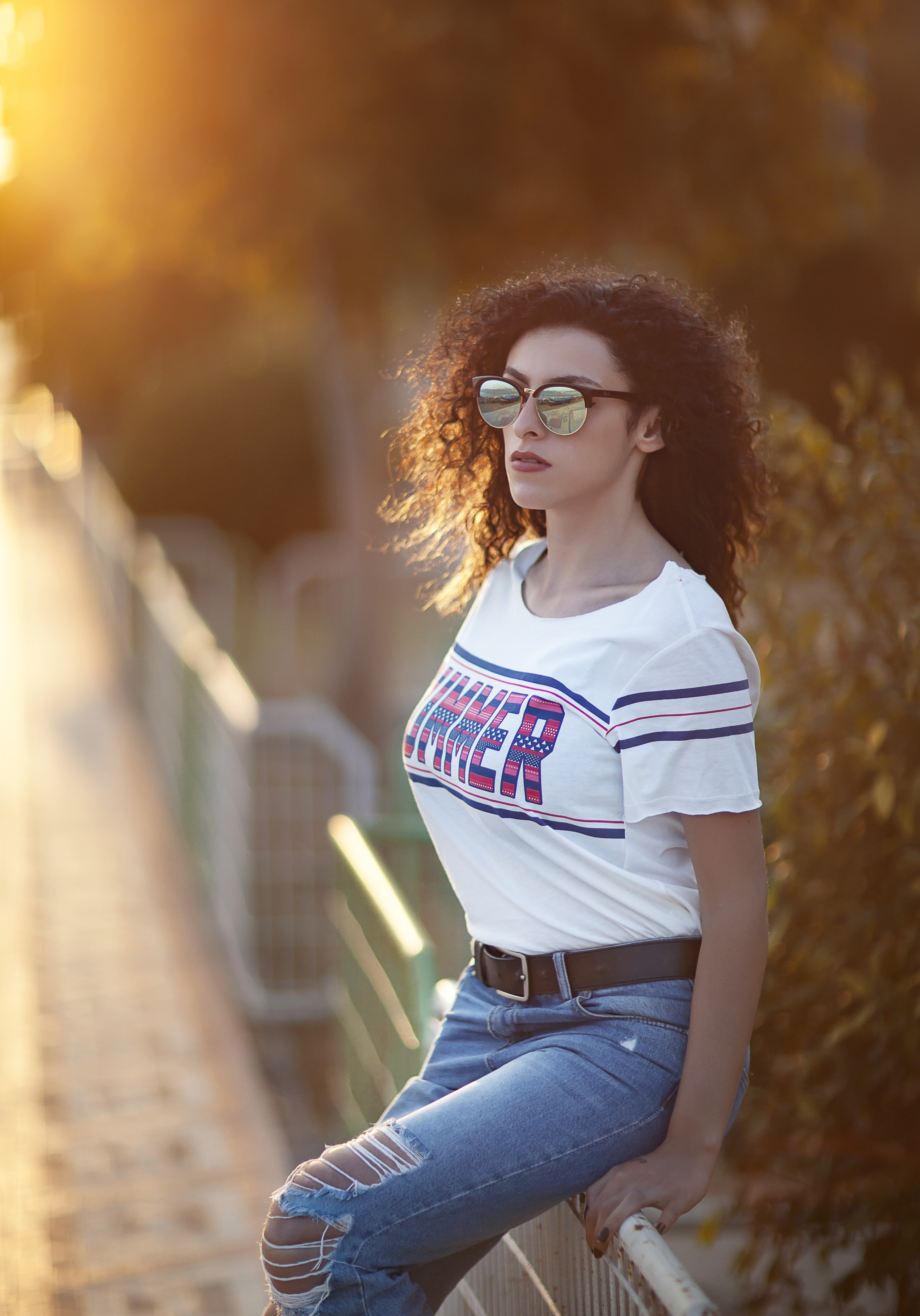 Woman with curly hair wearing sunglasses and a t-shirt HD Wallpaper