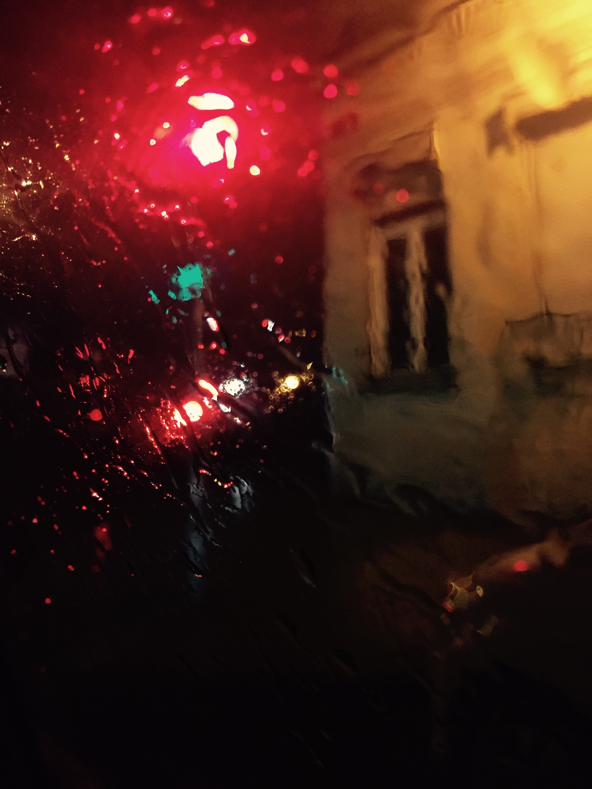 Rainy night with red and green lights and a building HD Wallpaper