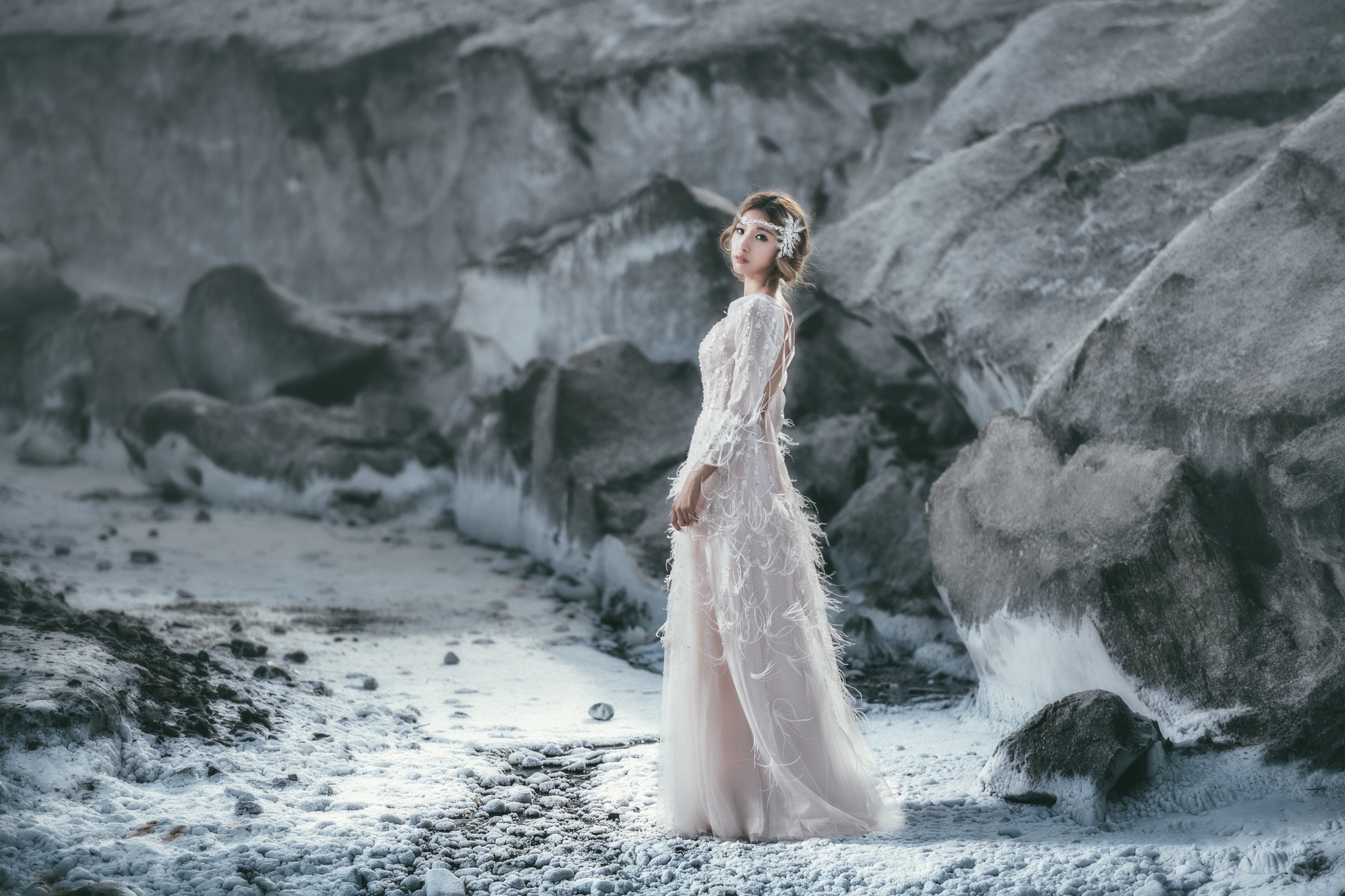 Woman in a white dress in a rocky, icy landscape HD Wallpaper