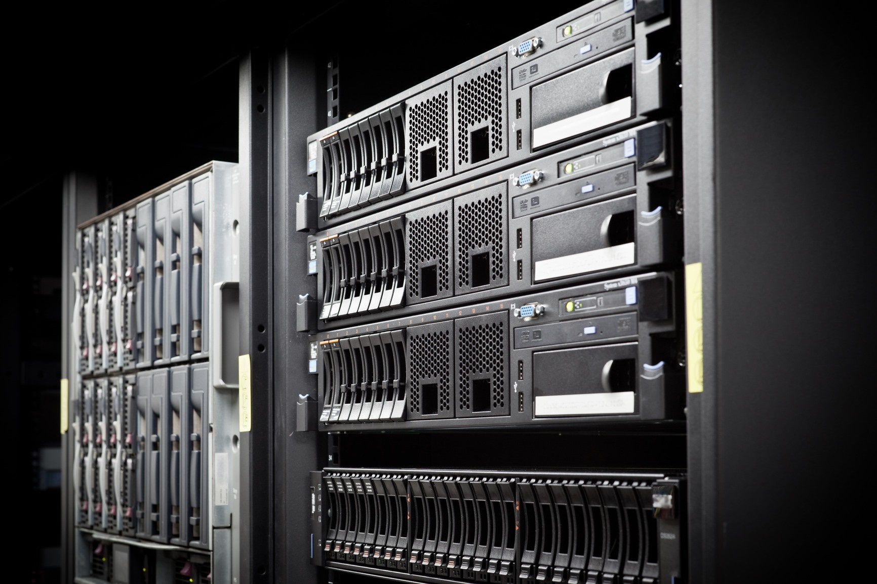 Server rack with multiple hard drive bays and computer hardware HD Wallpaper