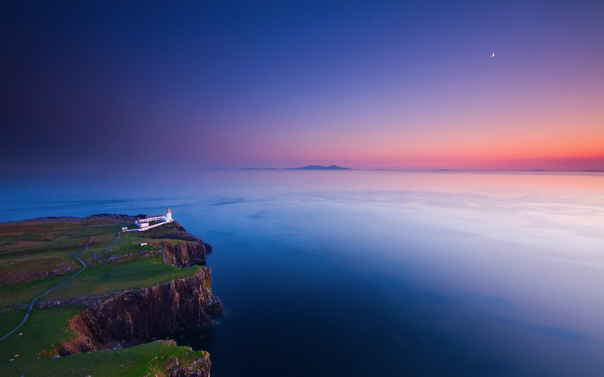 Lighthouse on a cliff overlooking the sea at sunset HD Wallpaper
