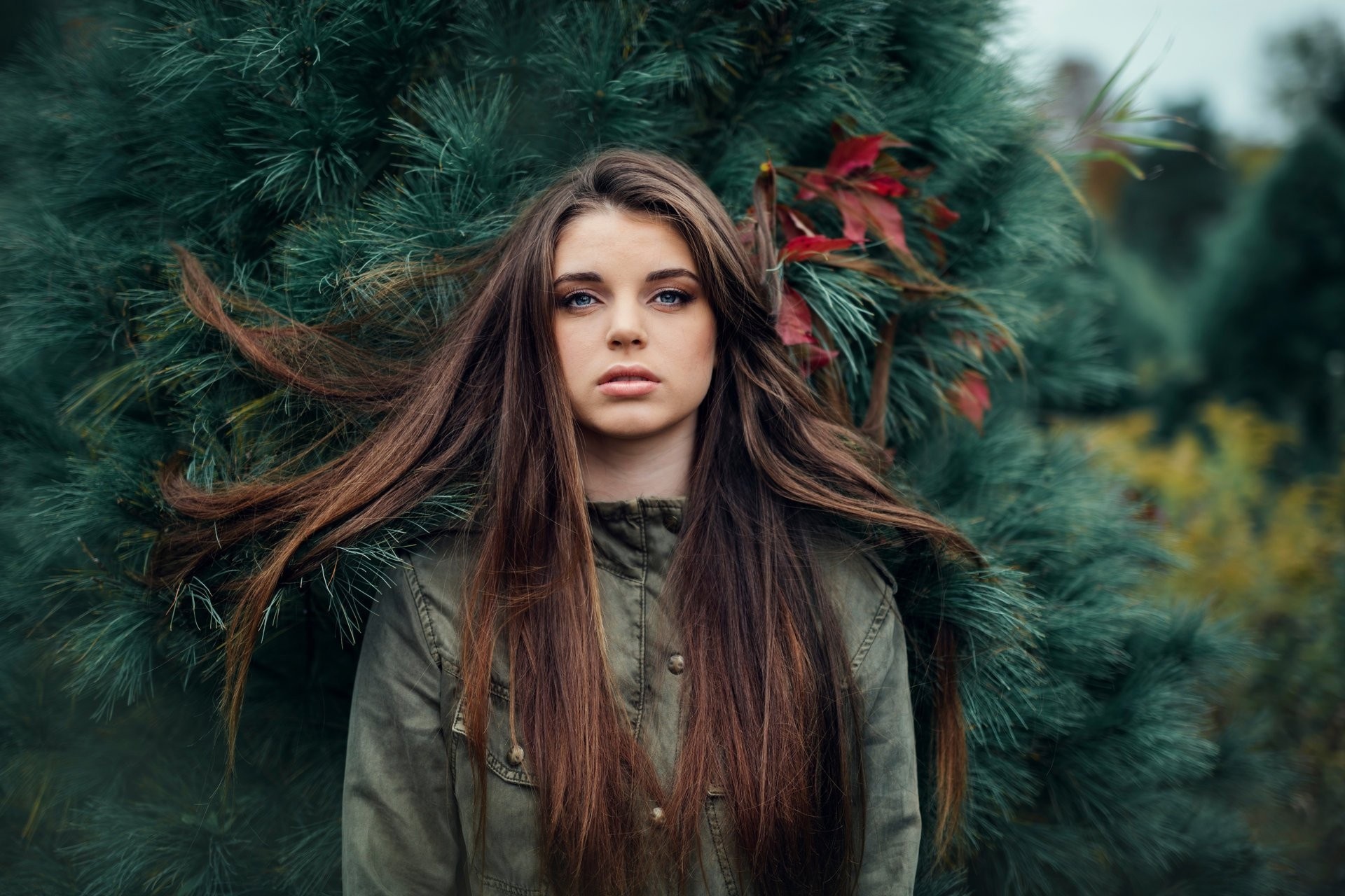 Woman with long brown hair in a green jacket HD Wallpaper