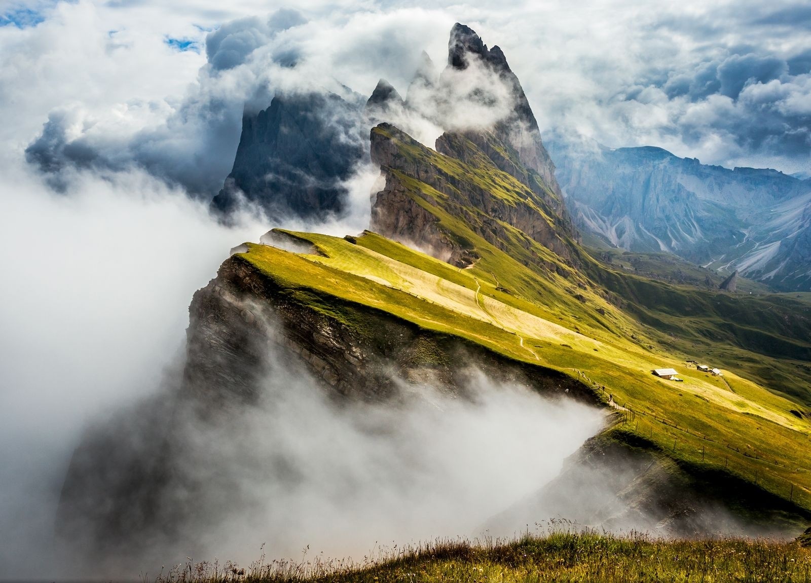 Mountain ridge with clouds and cabins in the Alps HD Wallpaper