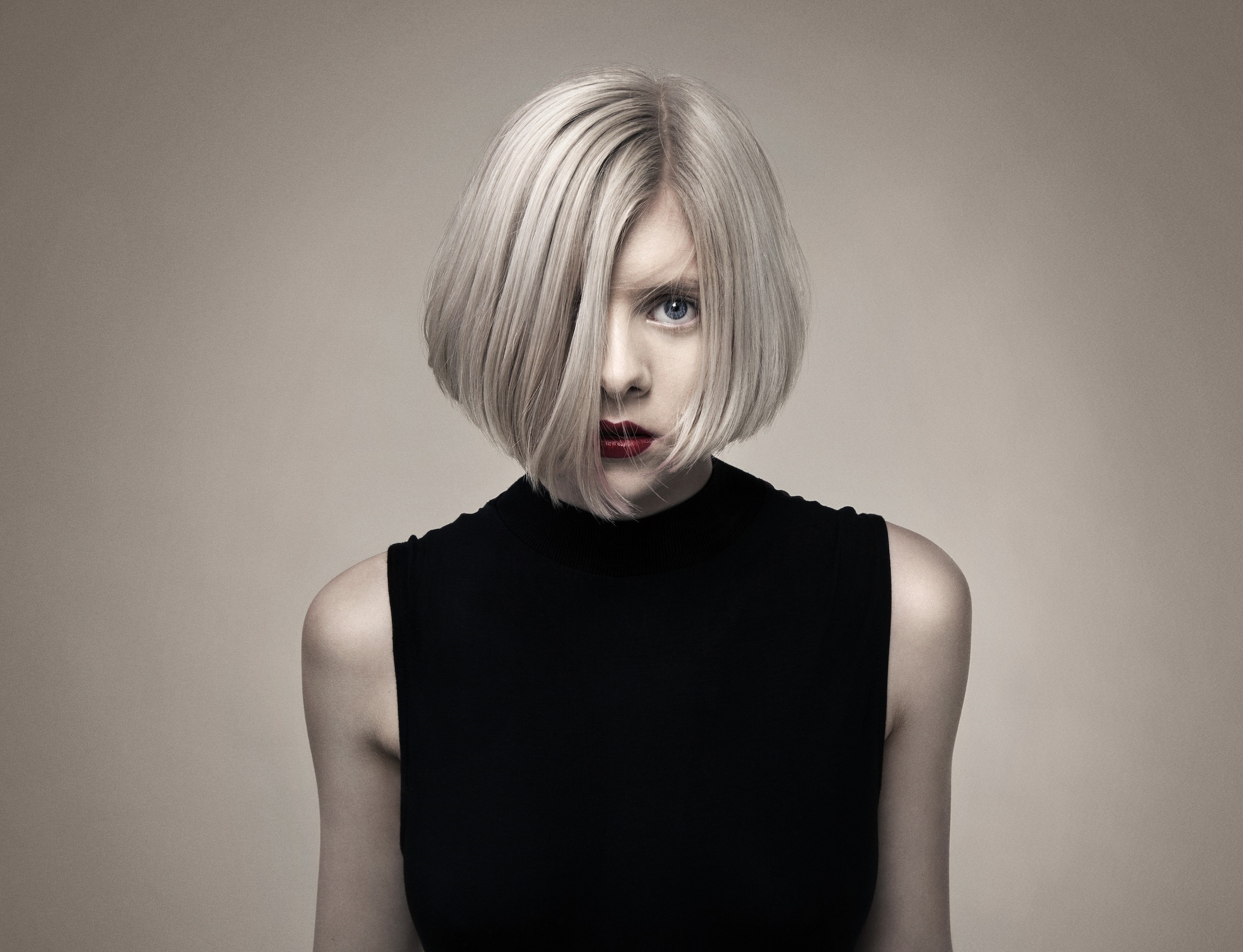 Portrait of Woman with Blonde Bob and Intense Gaze HD Wallpaper