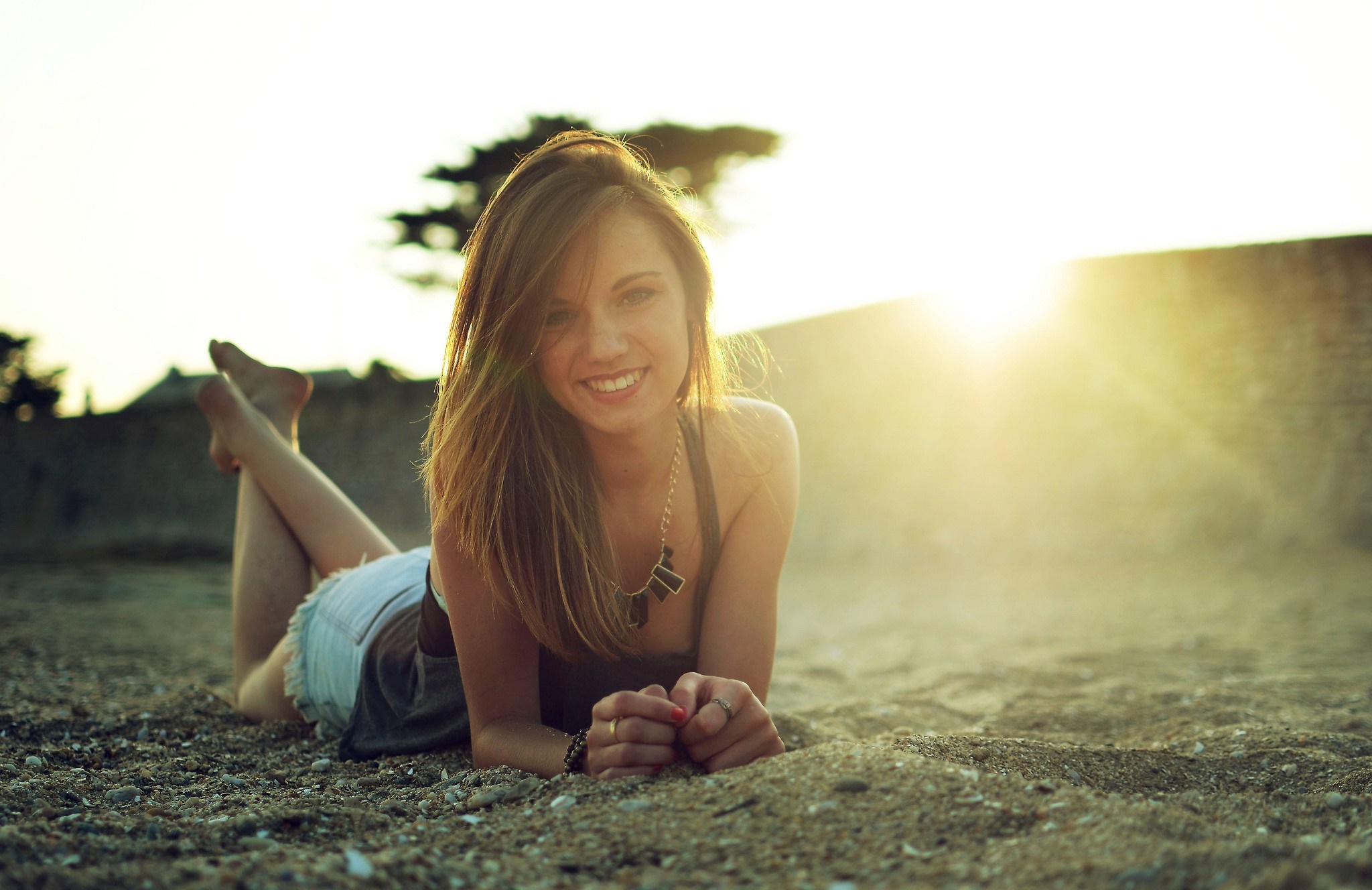 Woman lying on the beach at sunset HD Wallpaper