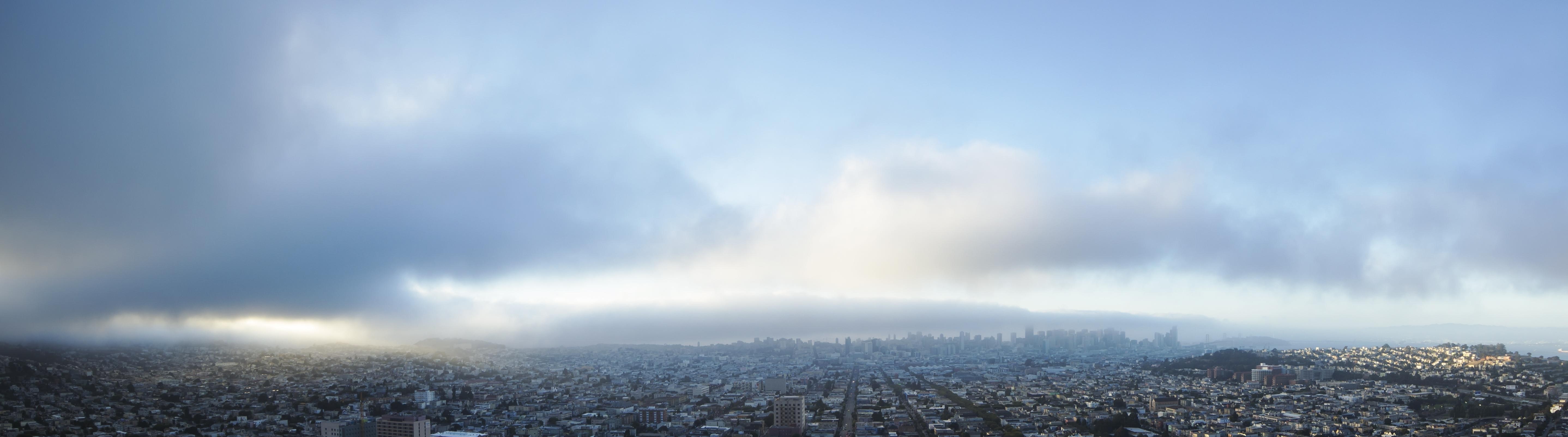 Panoramic view of San Francisco skyline through fog HD Wallpaper